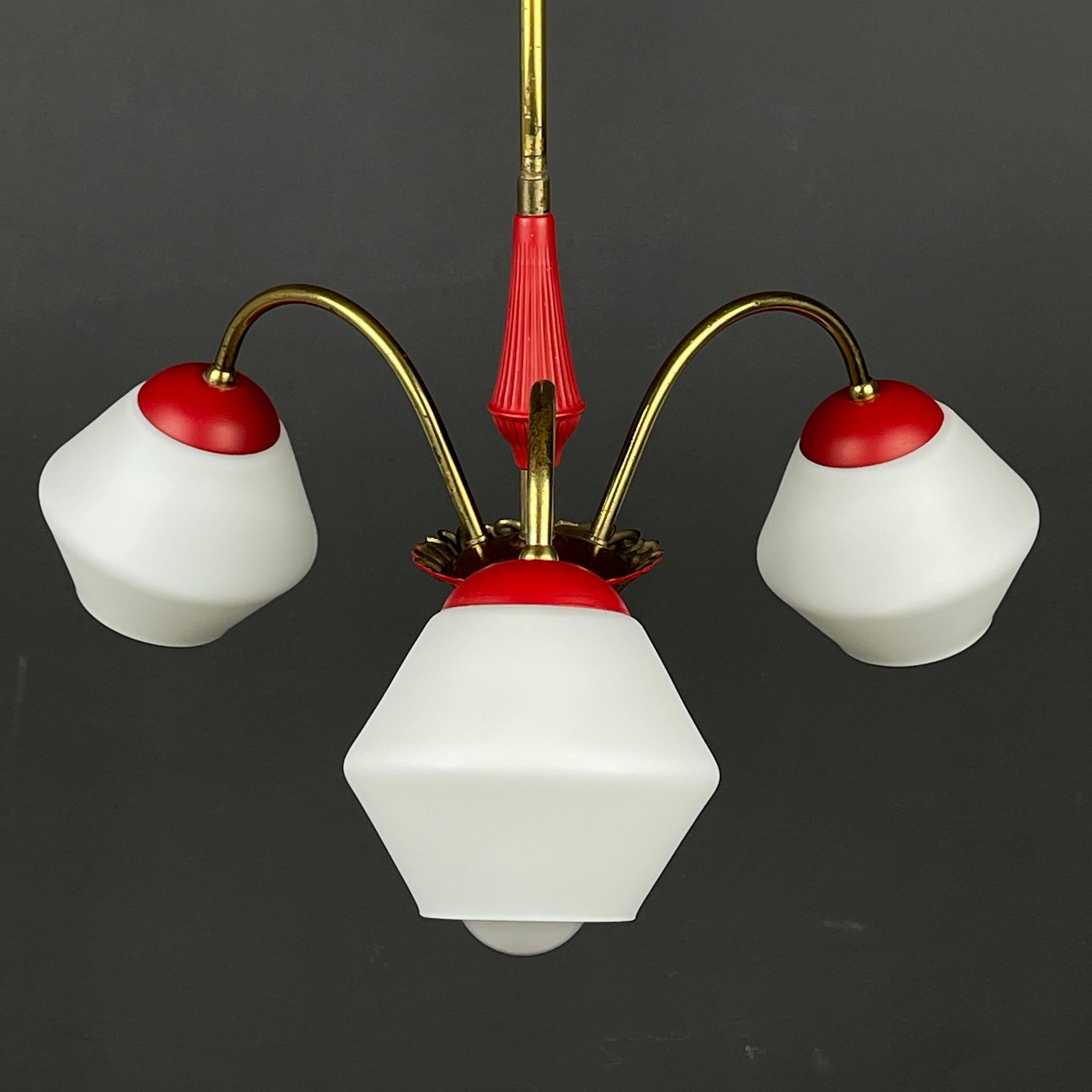Add a touch of timeless elegance to your space with this stunning vintage 3-arm chandelier. Crafted in Italy during the late 1950s, this piece showcases the epitome of Italian design from the mid-century era. The chandelier features a sturdy frame