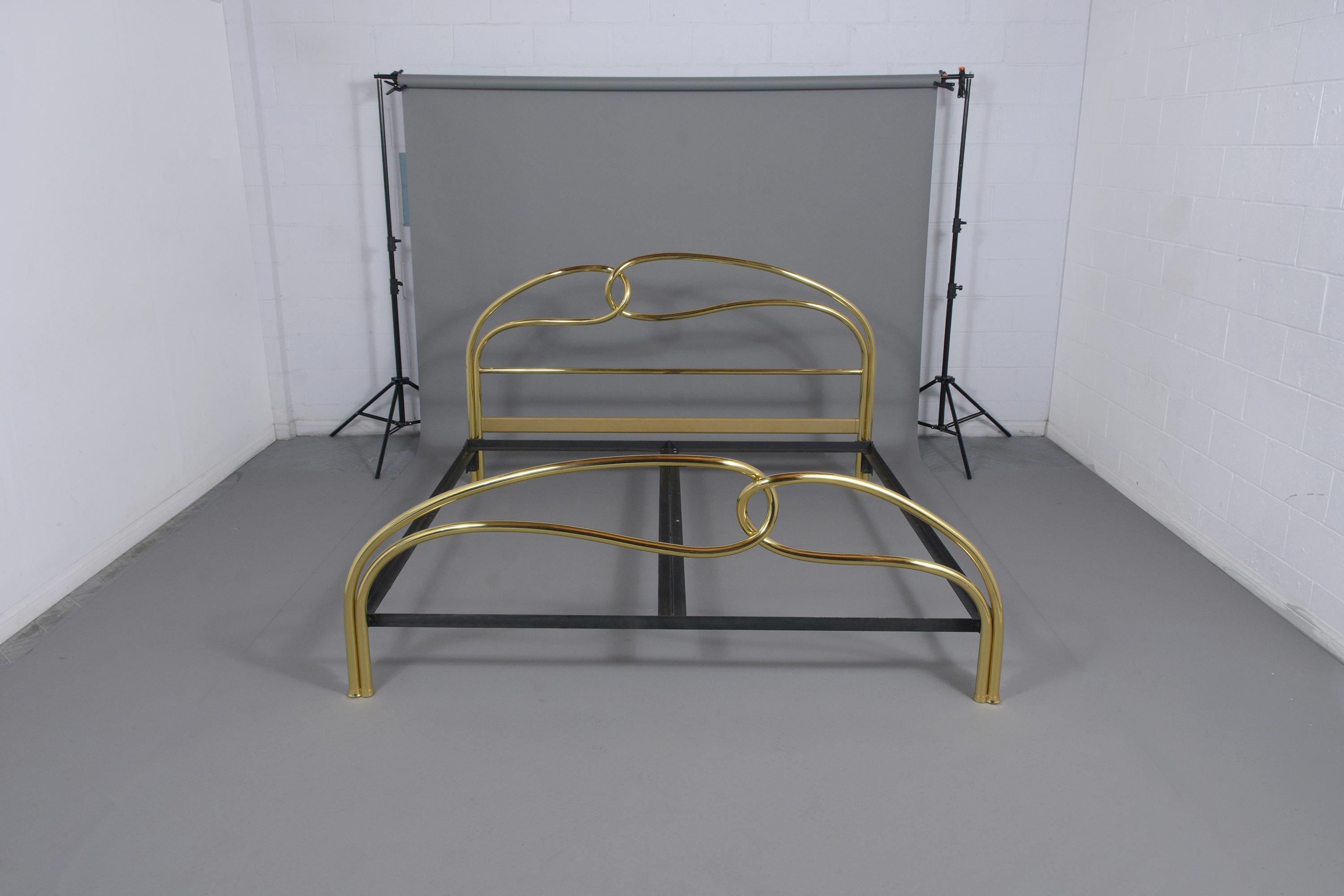 A vintage Mid-Century Modern Italian king-size bed frame hand-crafted out of brass features a unique design on the headboard and footboard, and original metal rails painted in black color. This art deco style bed frame is in great condition a