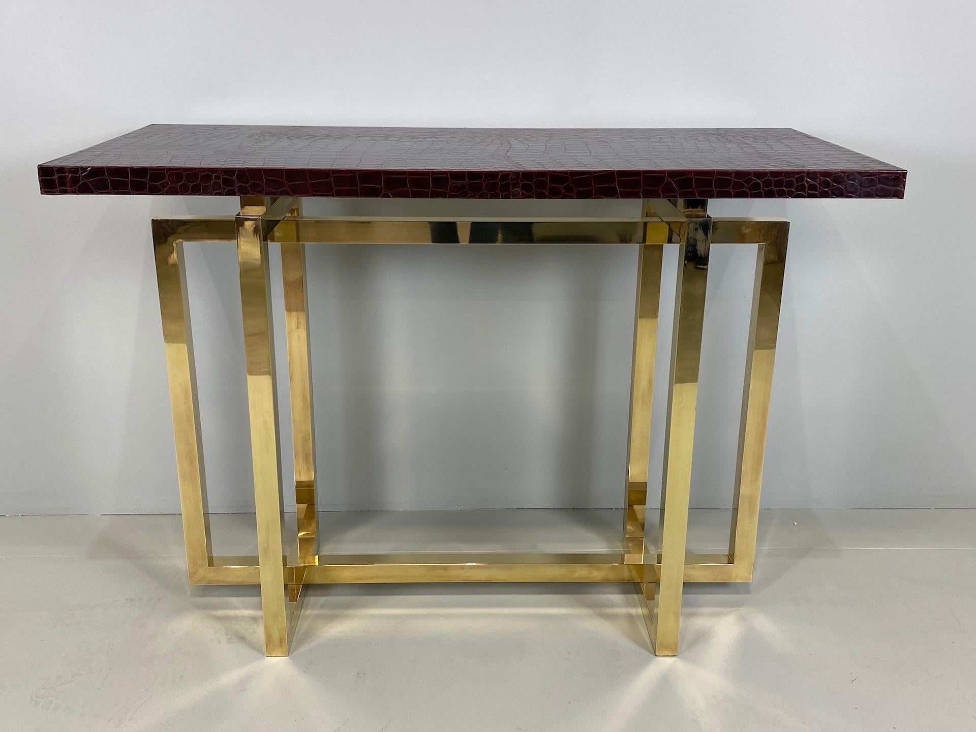 Vintage Italian brass console table with crocodile stamped leather top.
Consolle available is two.