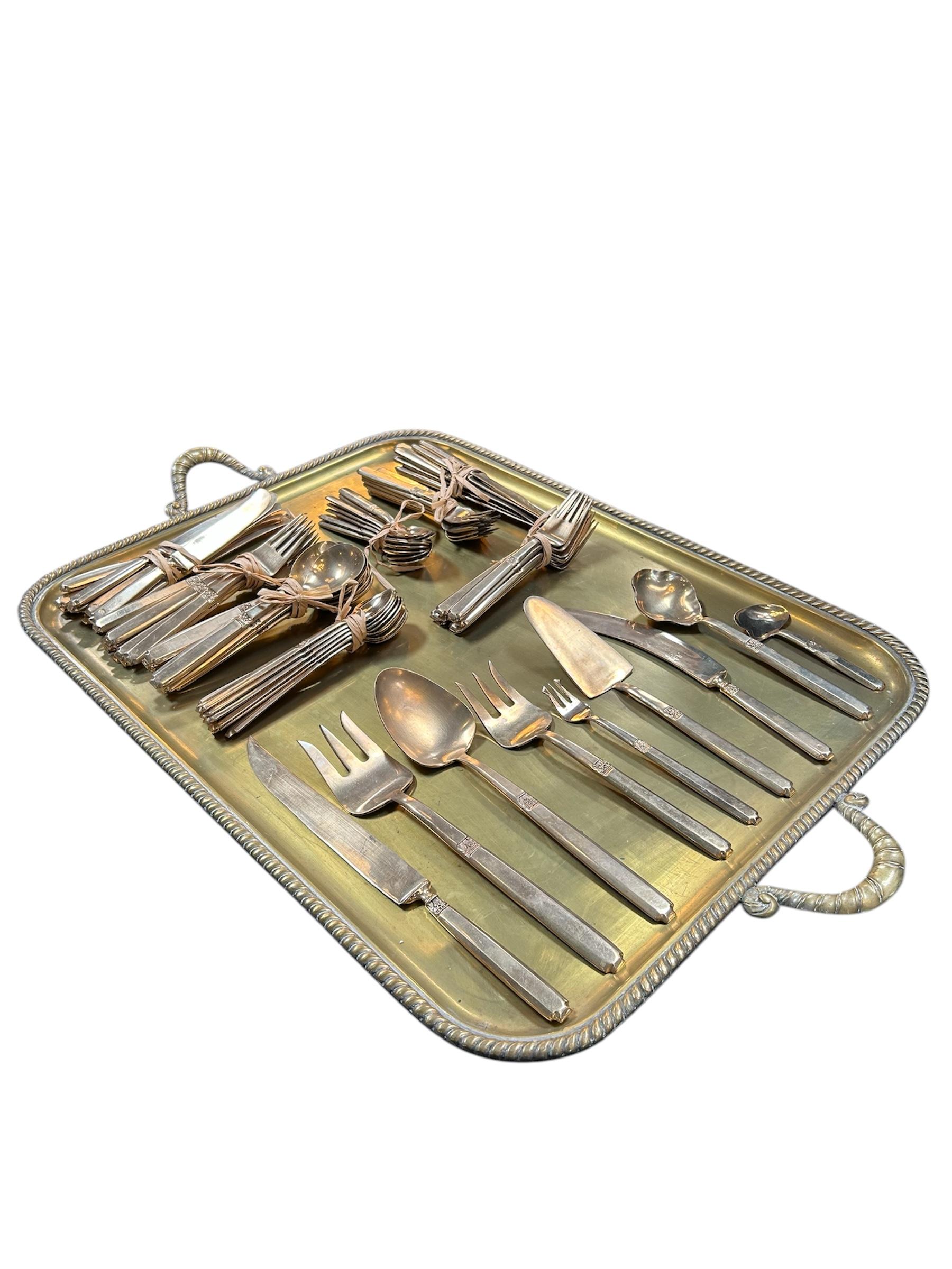 Beautifully crafted Italian flatware set features a refined, mid-century design with subtle decorative accents. Paired with a solid brass tray adorned with rope-twist handles, the ensemble exudes timeless elegance. Perfect for entertaining or