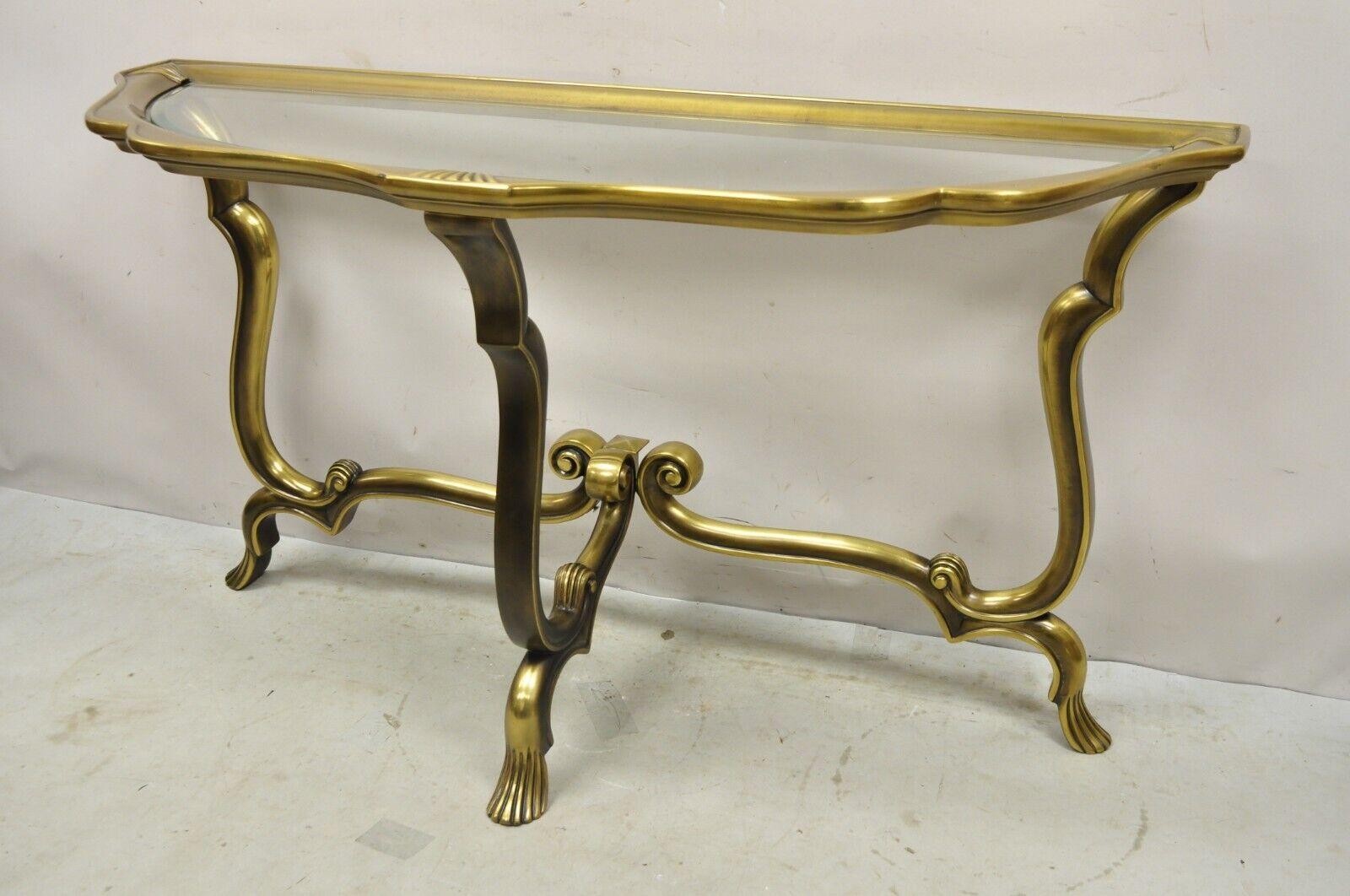 Vintage Italian Brass Hollywood Regency Glass Top Console Sofa Hall Table. Item features a burnished brass finish, metal frame, Beveled glass top, sleek sculptural form. Circa Mid to late 20th Century. Measurements: 28.5