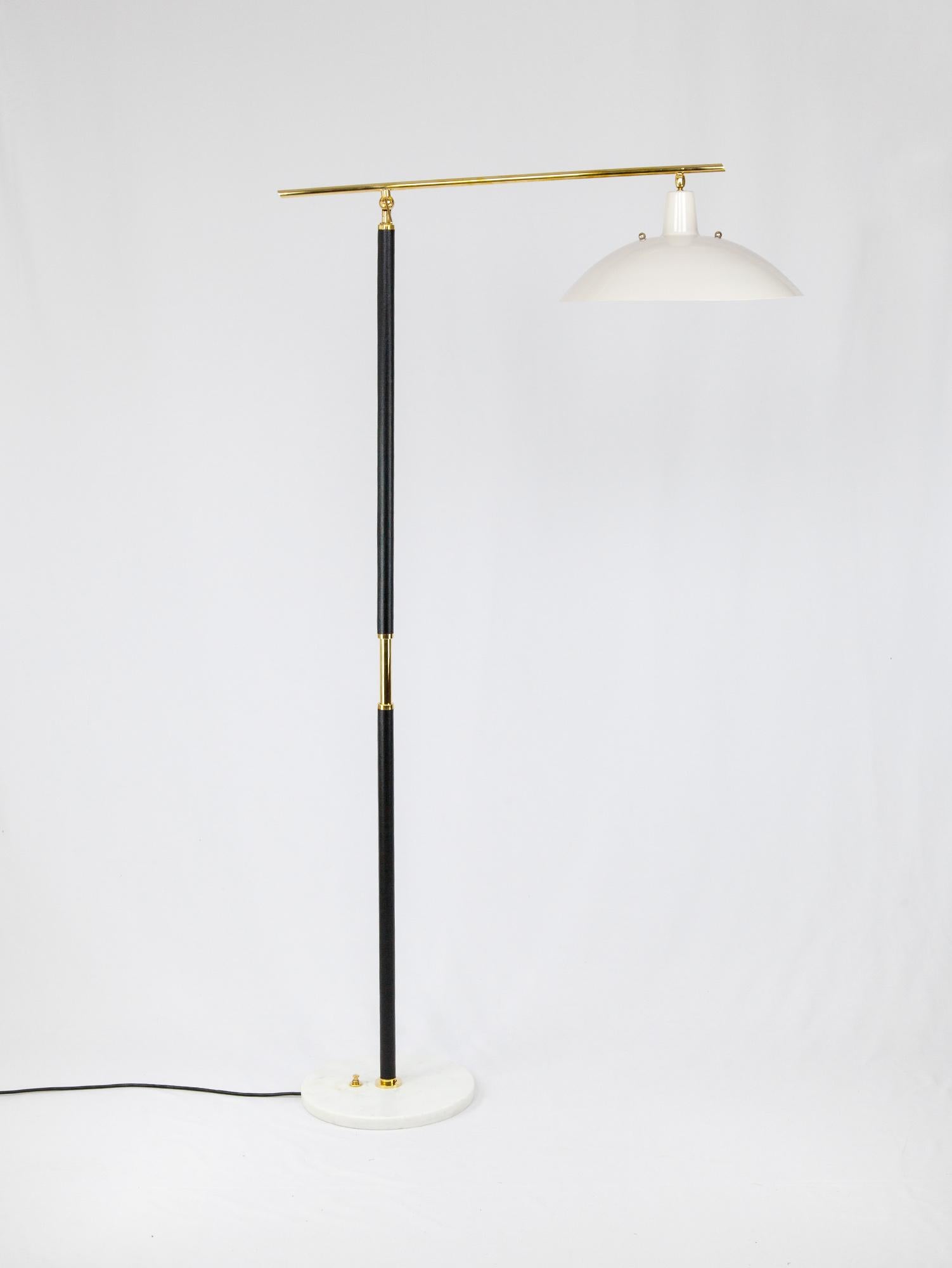 Sleek and tall Italian floor lamp with brass and marble details. The long brass arm and white metal shade are complimented by a black vinyl wrapped stand and white marble base. Beautiful Italian craftsmanship is seen throughout in the details. Both