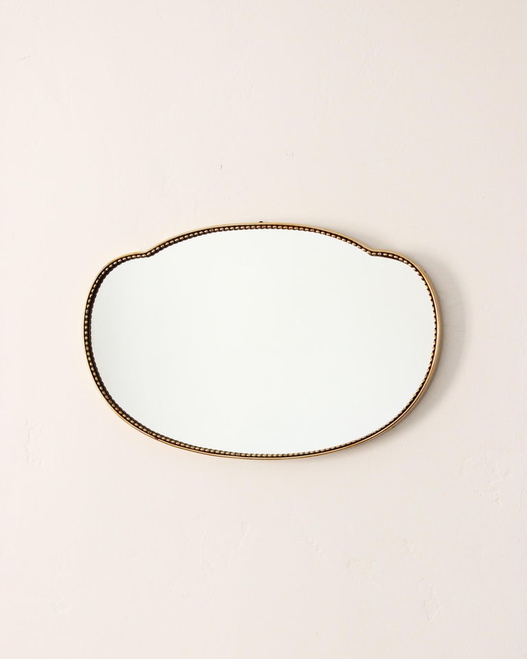 Organic wall mirror in the bean shape, produced in Italy, 1950s. Organically cut mirror glass is framed brass.

Other designers of the period include Gio Ponti, Fontana Arte, Max Ingrand, Franco Albini, and Josef Frank.