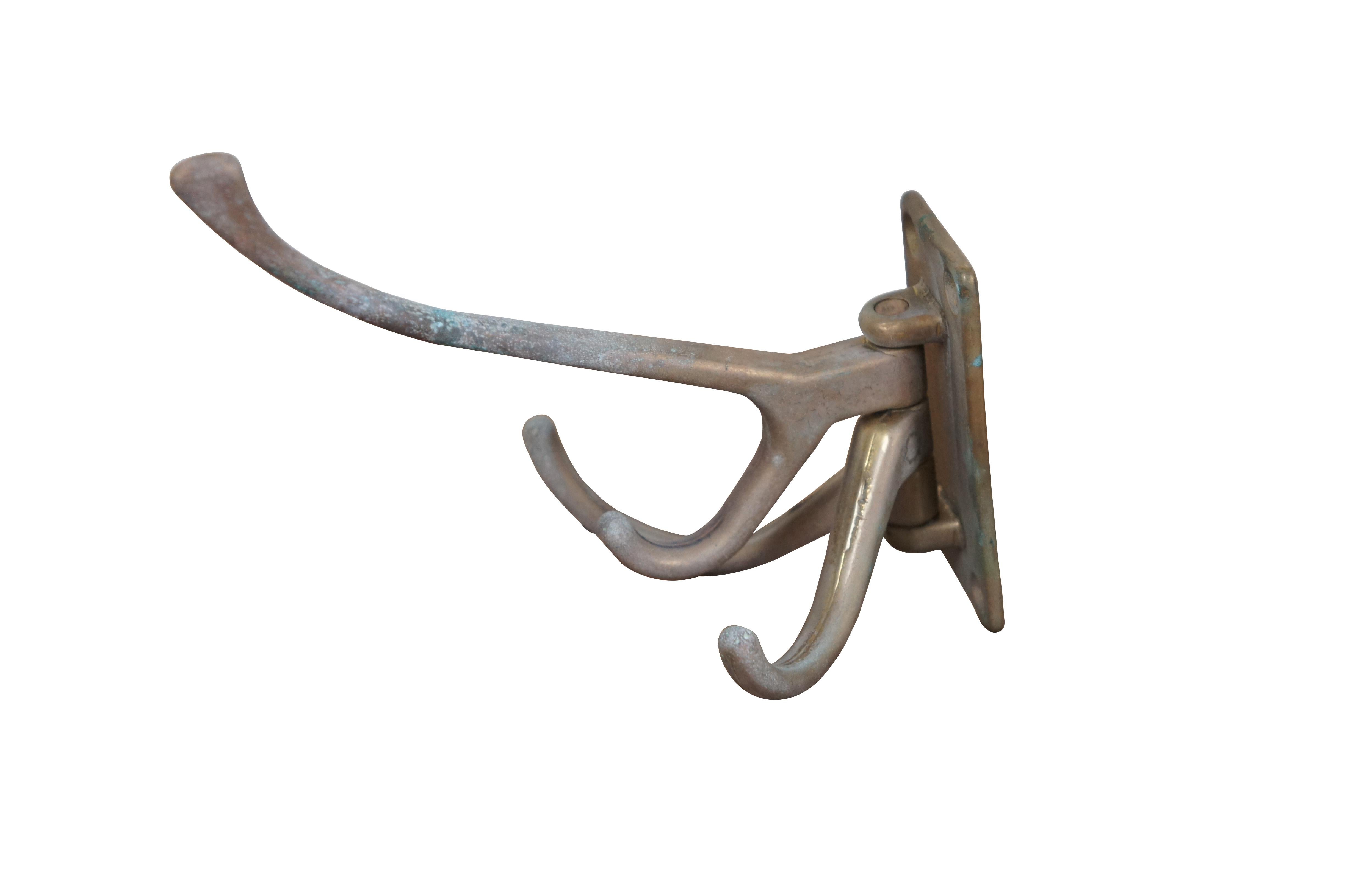 Mid to late 20th century brass coat / hat hook featuring a swiveling multi-use design with one large and small double hook at the top and top smaller single hooks below. Made in Italy.

Dimensions:
5