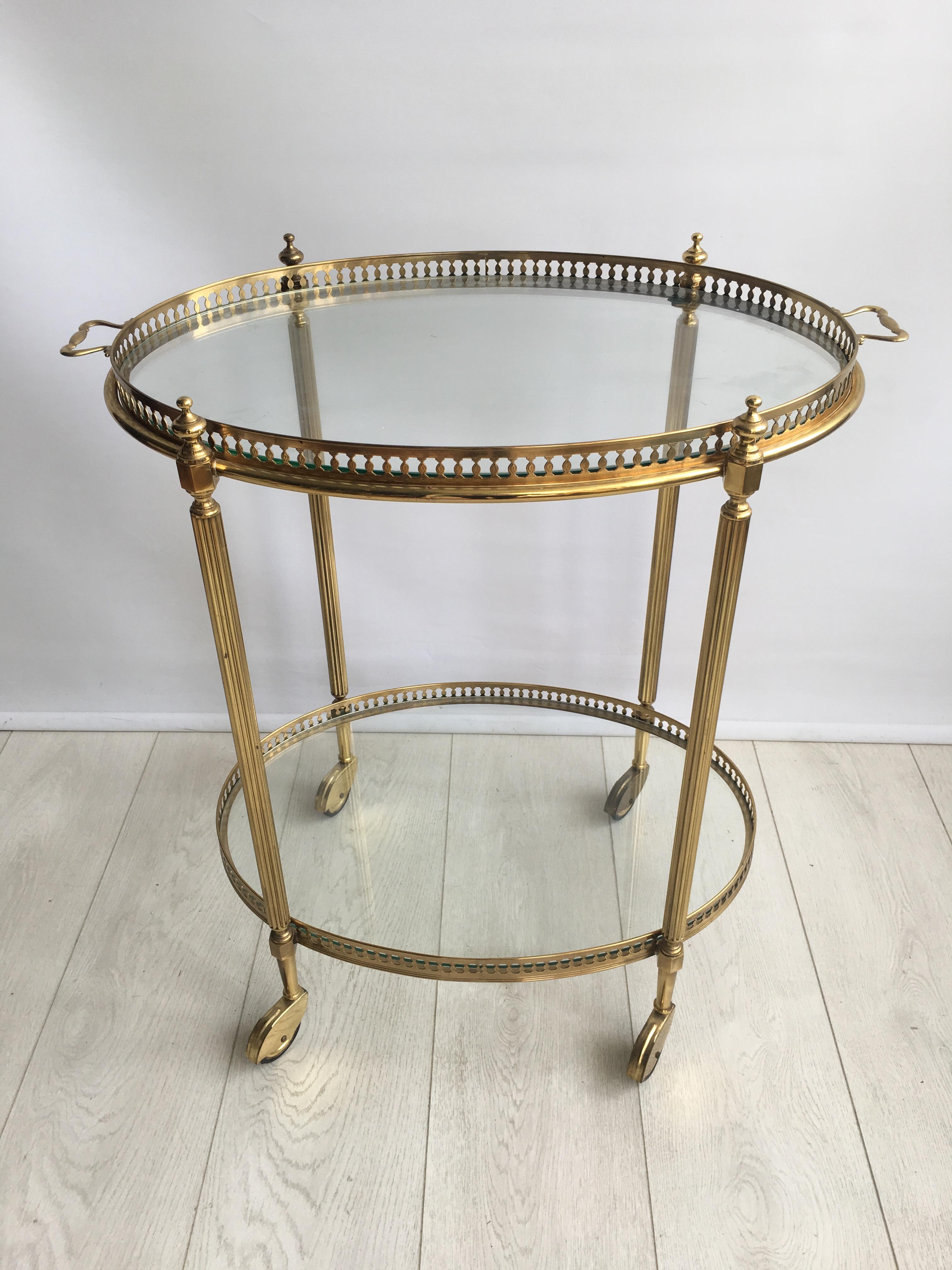 Attractive vintage drinks trolley from Italy, circa 1950.

Original lacquered brass frame with lift off top tray and decorative handles

Perfect for smaller spaces.

Top tray measures 54cm wide by 38cm deep and stands 63cm to the glass.