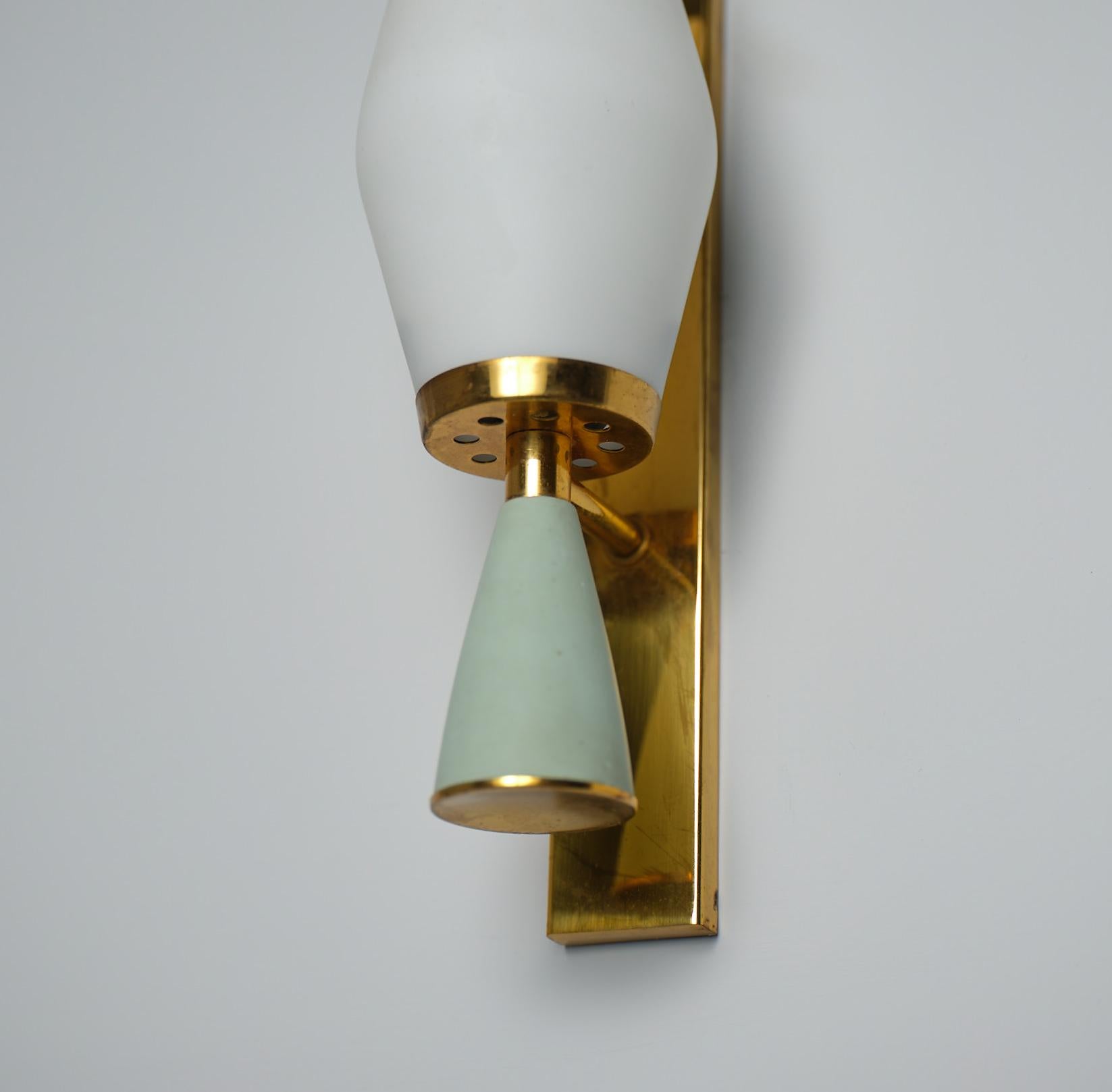 Pair of  vintage Italian Appliques , crafted in Italy during the 1950s, these sconces embody the refined style of the era. Made of brass with captivating sage green metal accents and opaline glass shades, each wall lamp exudes sophistication. While