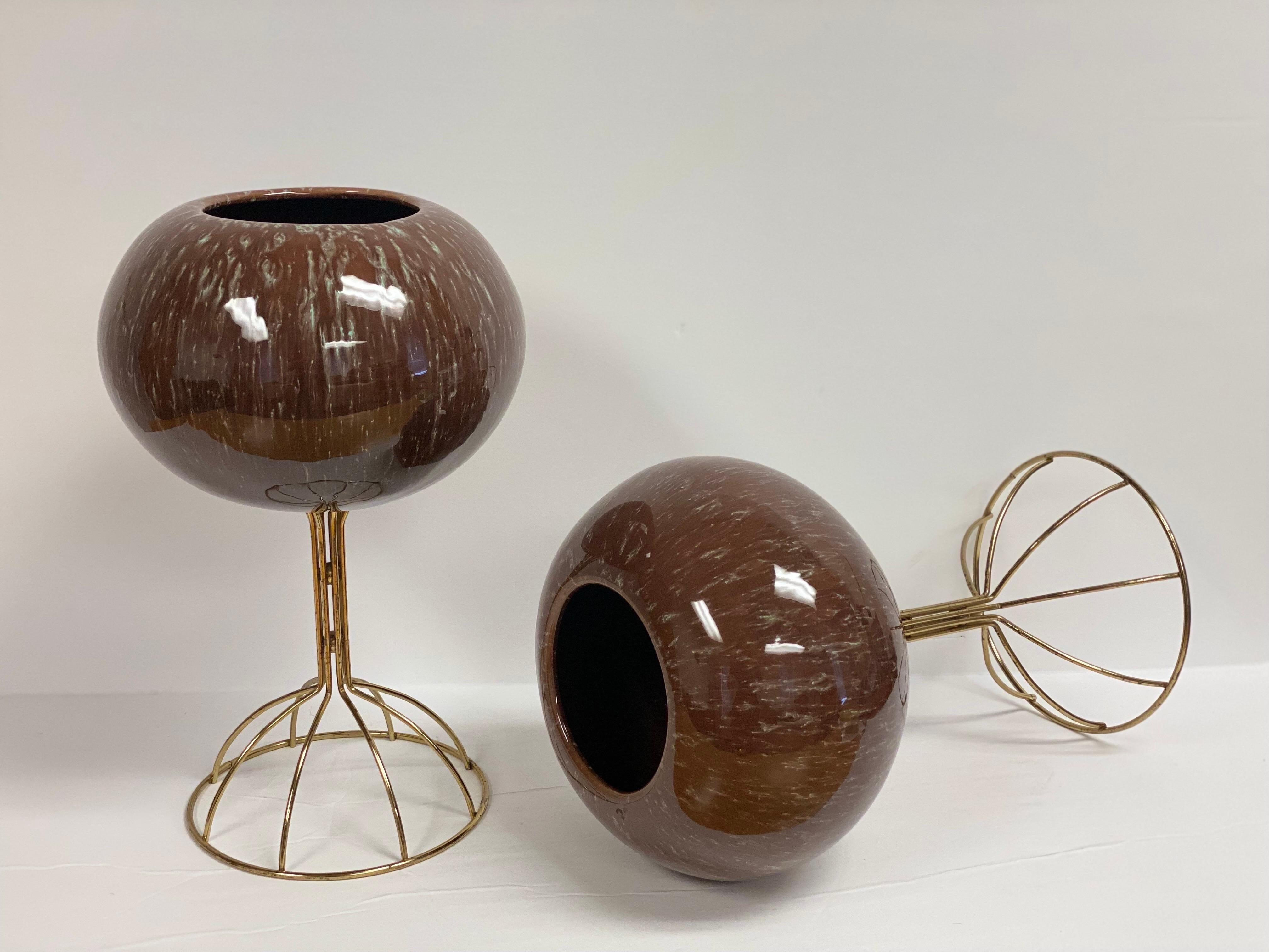 We are very pleased to offer a pair of vintage, Italian ceramic planters, circa the 1960s. Perfect for highlighting your favorite botanicals into any space, each planter showcases a beautiful, glazed brown ceramic sphere supported by a delicate and