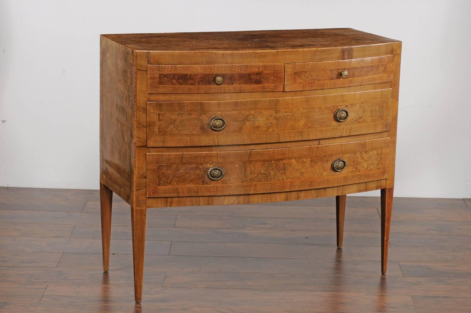 An Italian vintage bow front burl walnut veneered four-drawer commode from the mid-20th century. This Italian commode features an exquisite burl walnut quarter veneered top with crossbanded inlay, sitting above a bow front façade. Two thinner