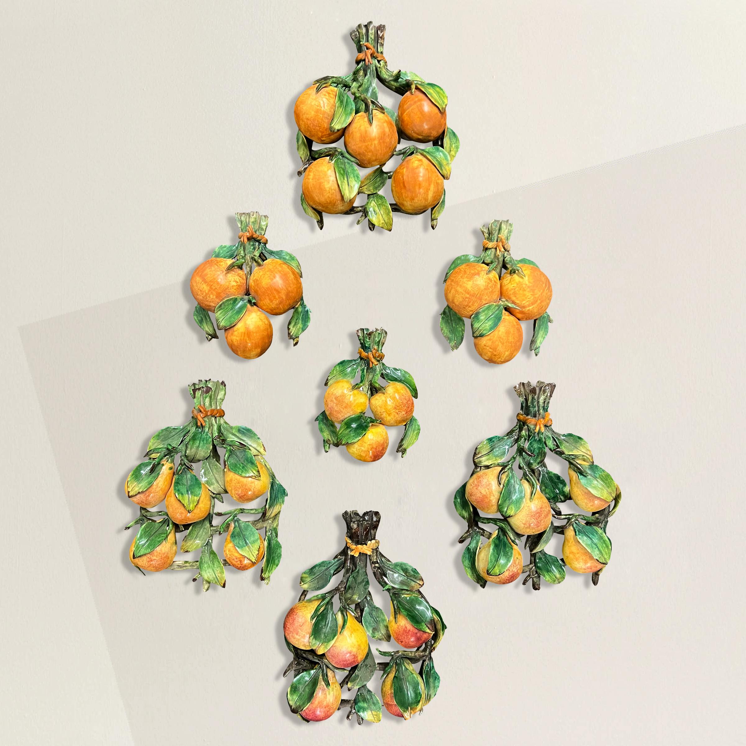A wonderfully whimsical collection of vintage Italian Capodimonte hand-painted porcelain fruits including oranges, pears, and apples, perfect for hanging in myriad arrangements in the kitchen of your country house.