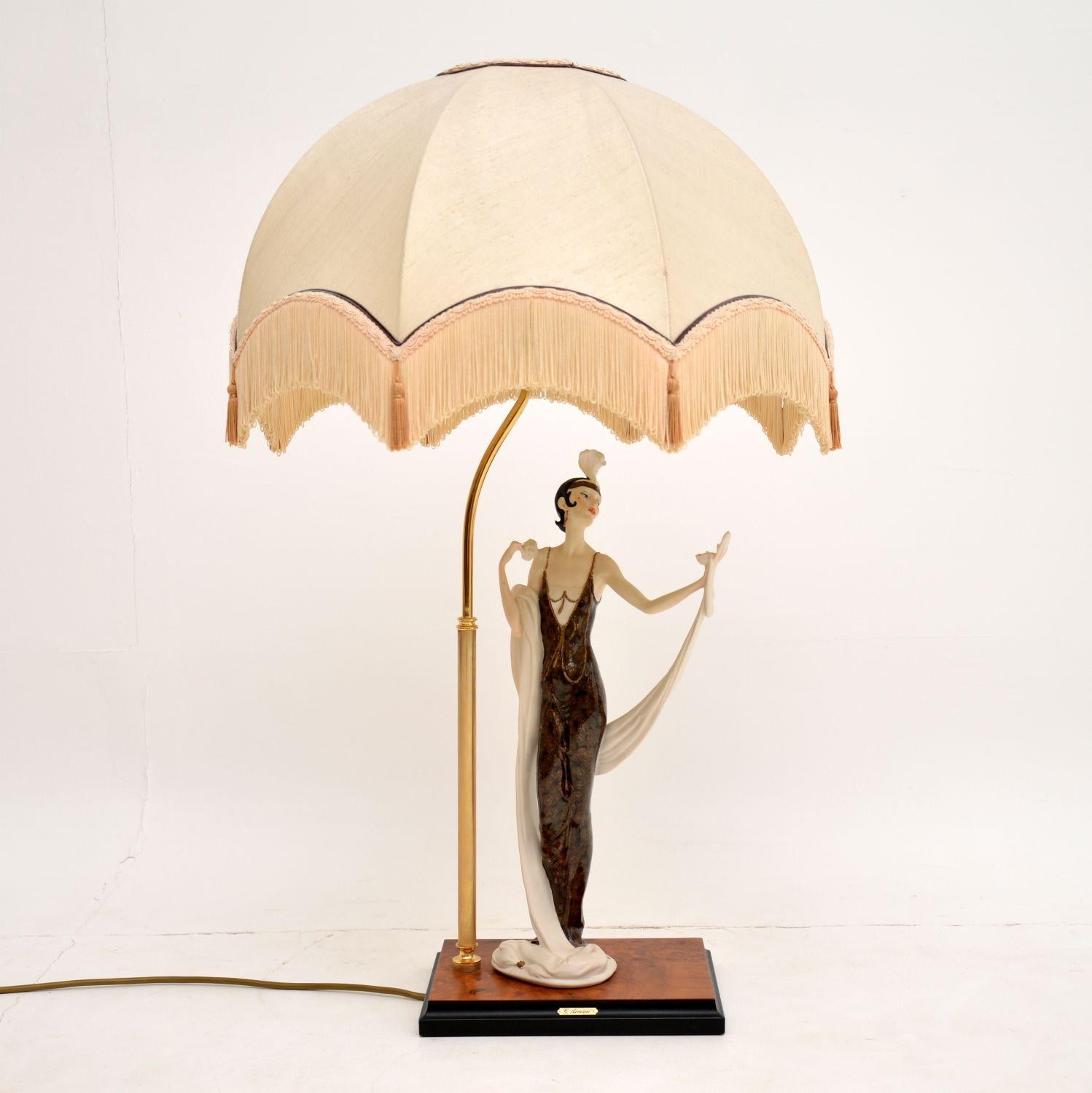 A stunning and quite large vintage porcelain Capodimonte table lamp, by the famous Italian artist Giuseppe Armani. This was issued in 1987, and this particular lamp was made in 1992.

It depicts an Art Deco era lady looking into a vanity mirror,