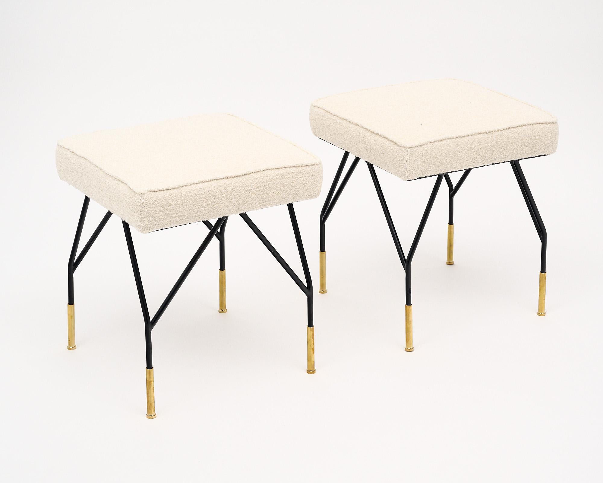 Pair of Italian stools with black lacquered steel and brass legs. New upholstery is done in a white wool blend.