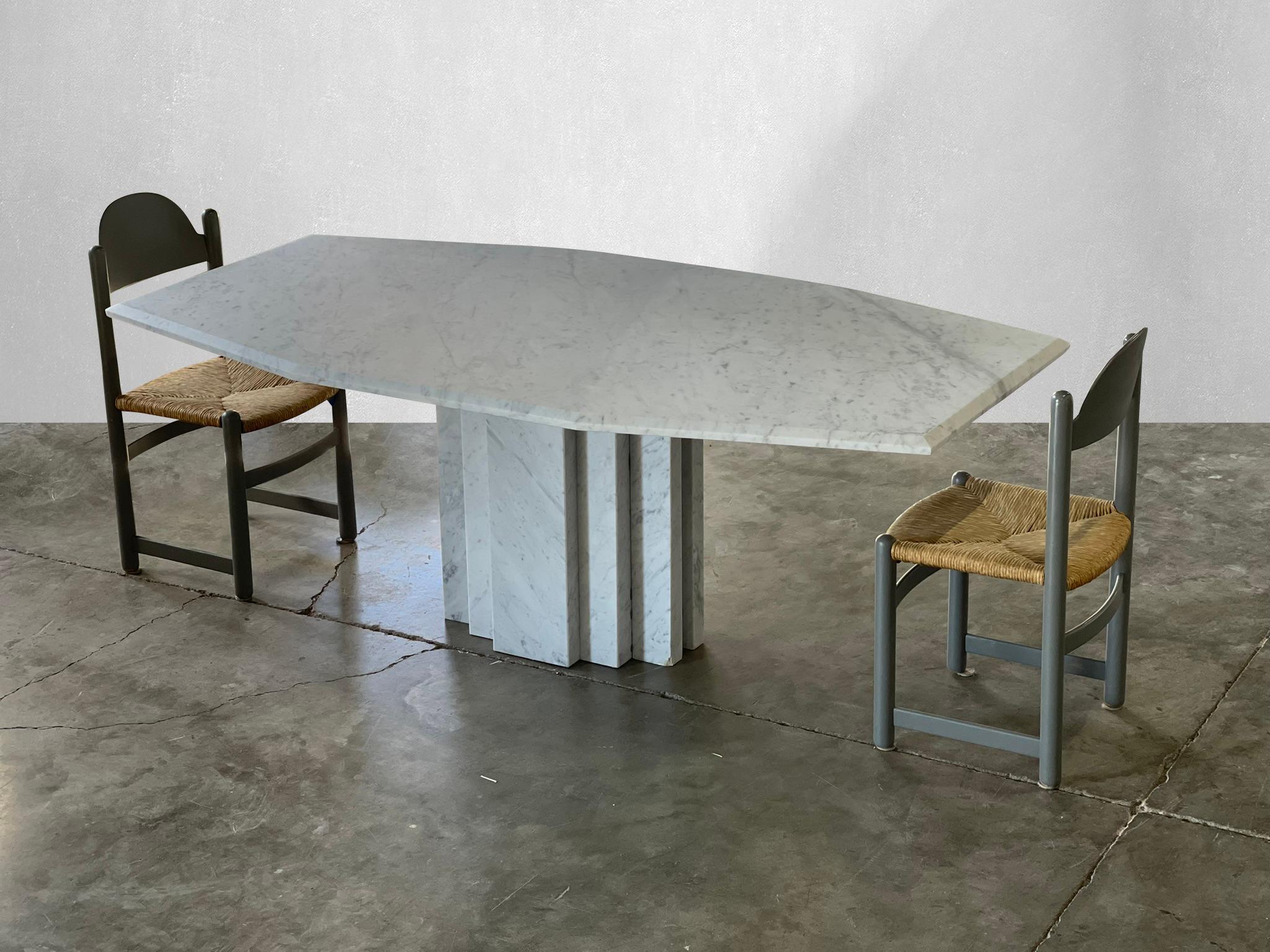 Monumental Carrara marble dining table with architectural base.

Stunning veining throughout the solid Carrara marble top and base. This table has a unique tapered marble top. The base is a show stopper. Comfortably seats 8 people.

 Has been