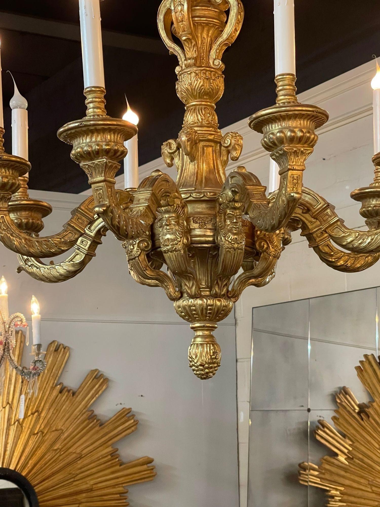 Very fine vintage Italian carved and giltwood 6 arm chandelier. Amazing carvings including faces on the arms. Beautiful gilt finish as well. A real work of art!!