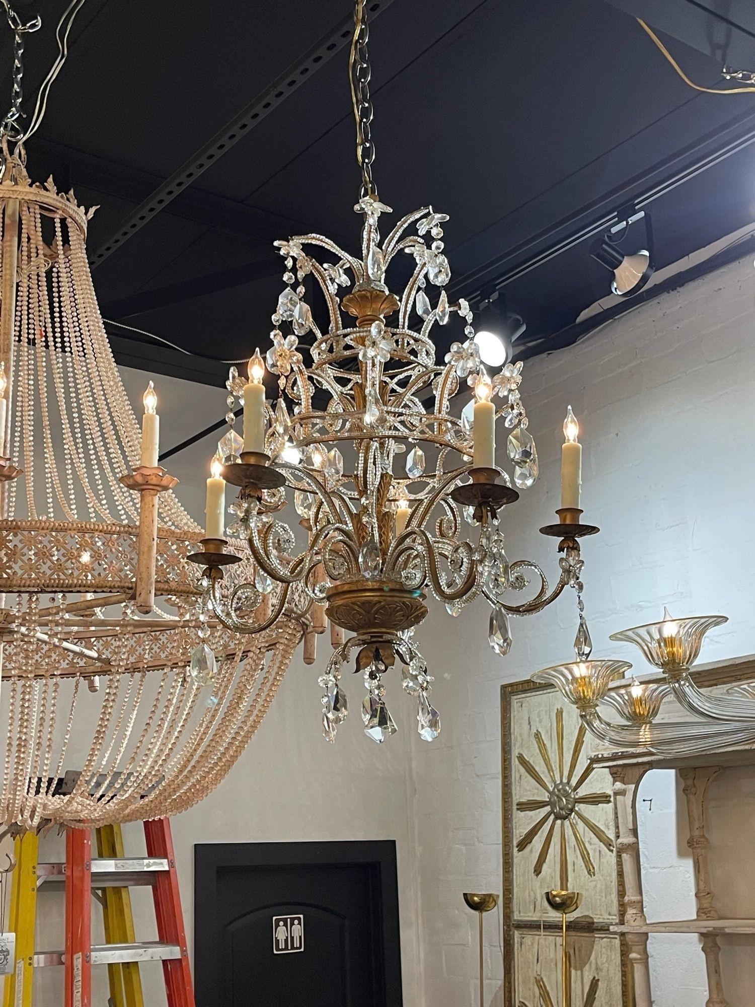Very fine vintage Italian carved and giltwood beaded crystal chandelier with 6 lights. Beautiful scale and shaped on this fixture and it is covered in beads and crystals. Adds a reach touch of elegance!!