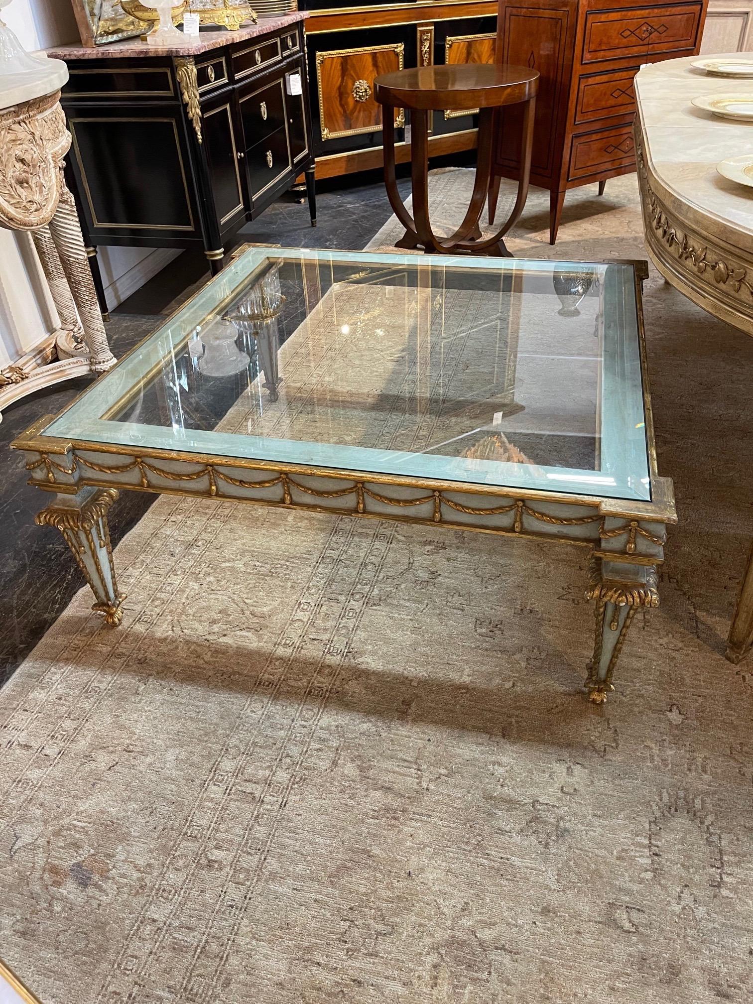 Decorative vintage Italian carved and parcel gilt coffee table. Lovely carvings and beautiful colors of creme, gold and pale blue. So pretty!