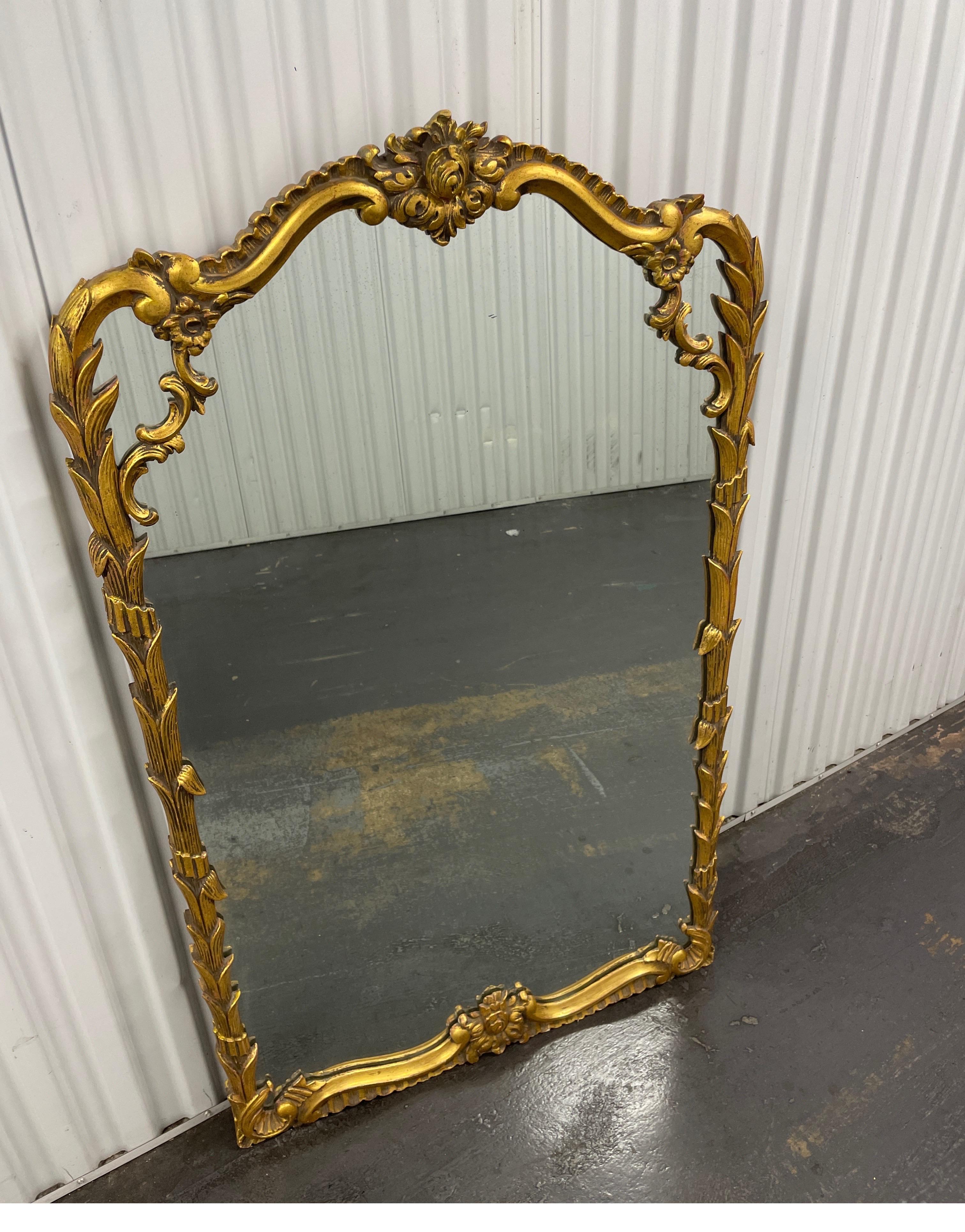 Vintage carved and gilded Italian wall mirror with leaves & flowers.