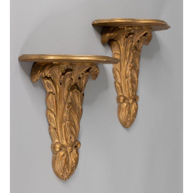 A stunning large pair of vintage Mid-Century Italian gilded wood wall brackets shelves. No maker's mark. These lovely brackets have a carved acanthus leaf design and are perfect for displaying decorative collectibles or fabulous on their own.

