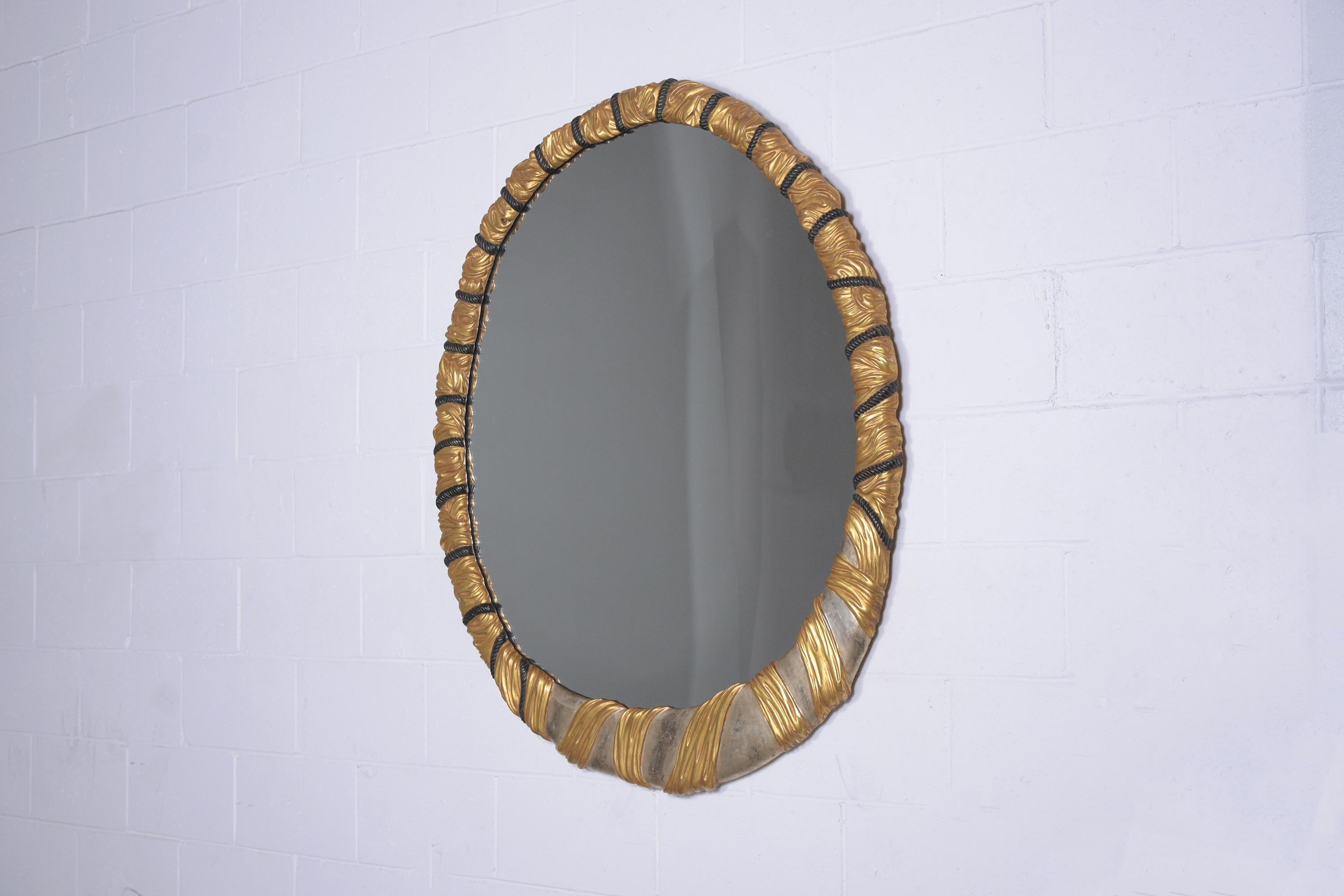 An extraordinary Italian wall mirror that is handcrafted out of wood and features a frame with a unique rope design with gold and silver-gilt finish and ebonized details The mirror is fully reflective and ready to be used for years to come.
Mirror: