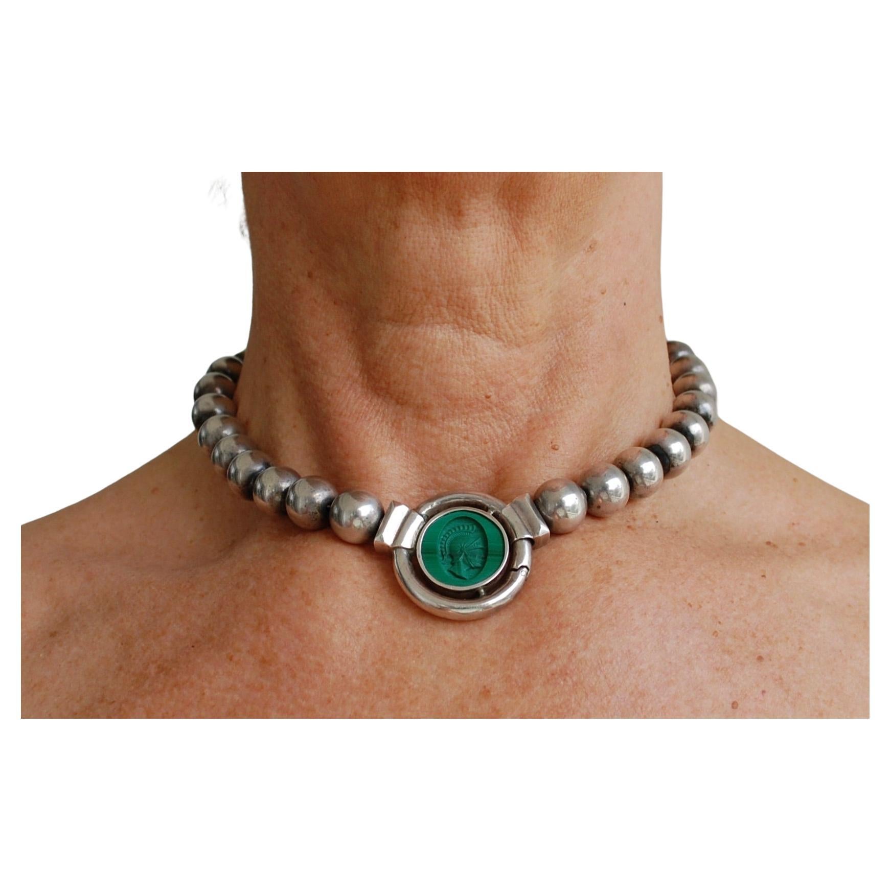 Stunning Italian Malachite and Sterling Silver choker necklace.
Vintage hand carved malachite round cameo depicting Roman soldier set in sterling silver and round beads, wonderful quality, no visible markings. About 16,5 inches, pendant 1,25 inch