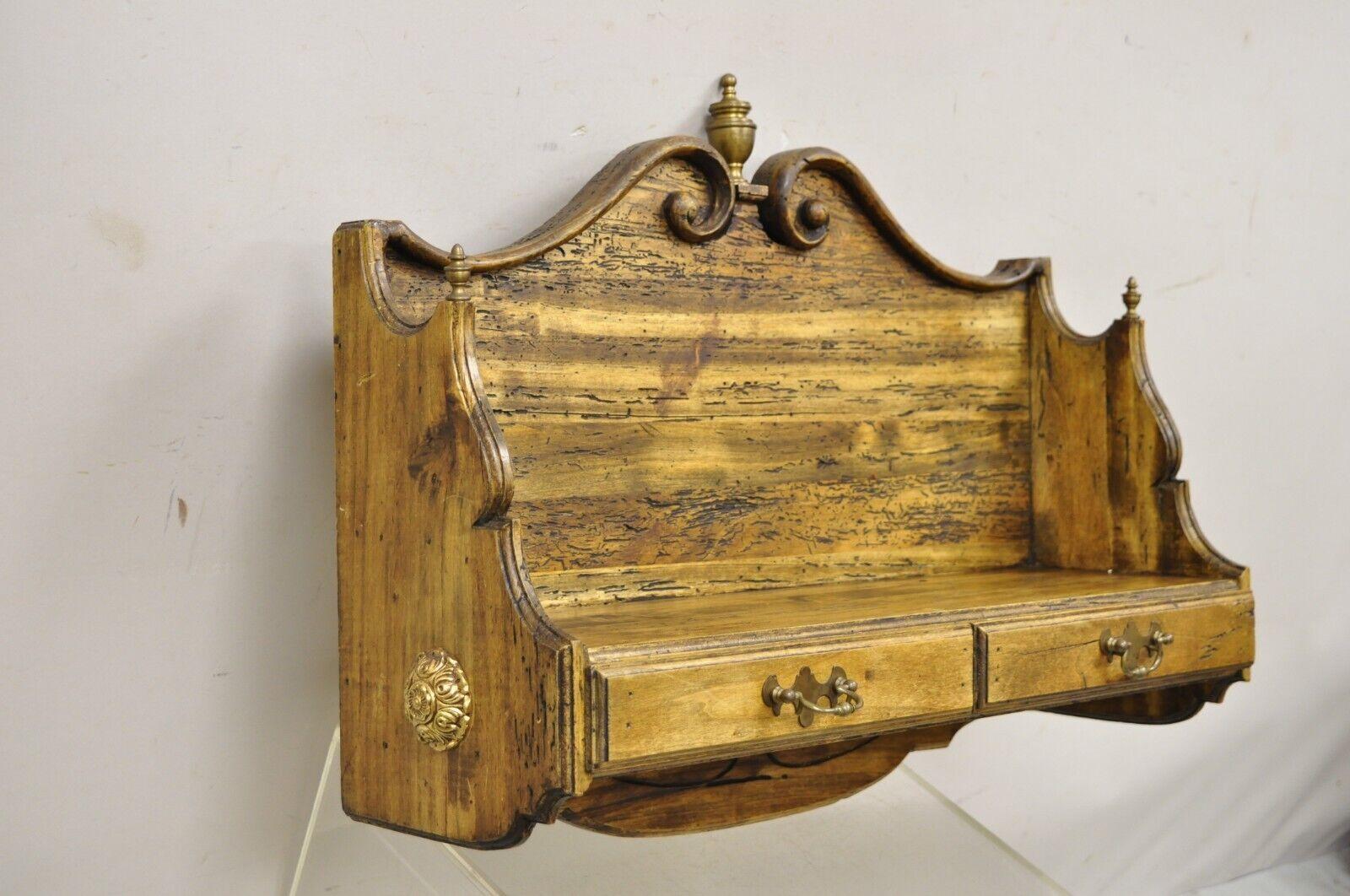 Vintage Italian Carved Wood Distressed French Country Wall Hanging Shelf Curio. Item features Two drawers, brass finials stamped, “Made in Italy”. Circa Late 20th Century. Measurements: 19.25