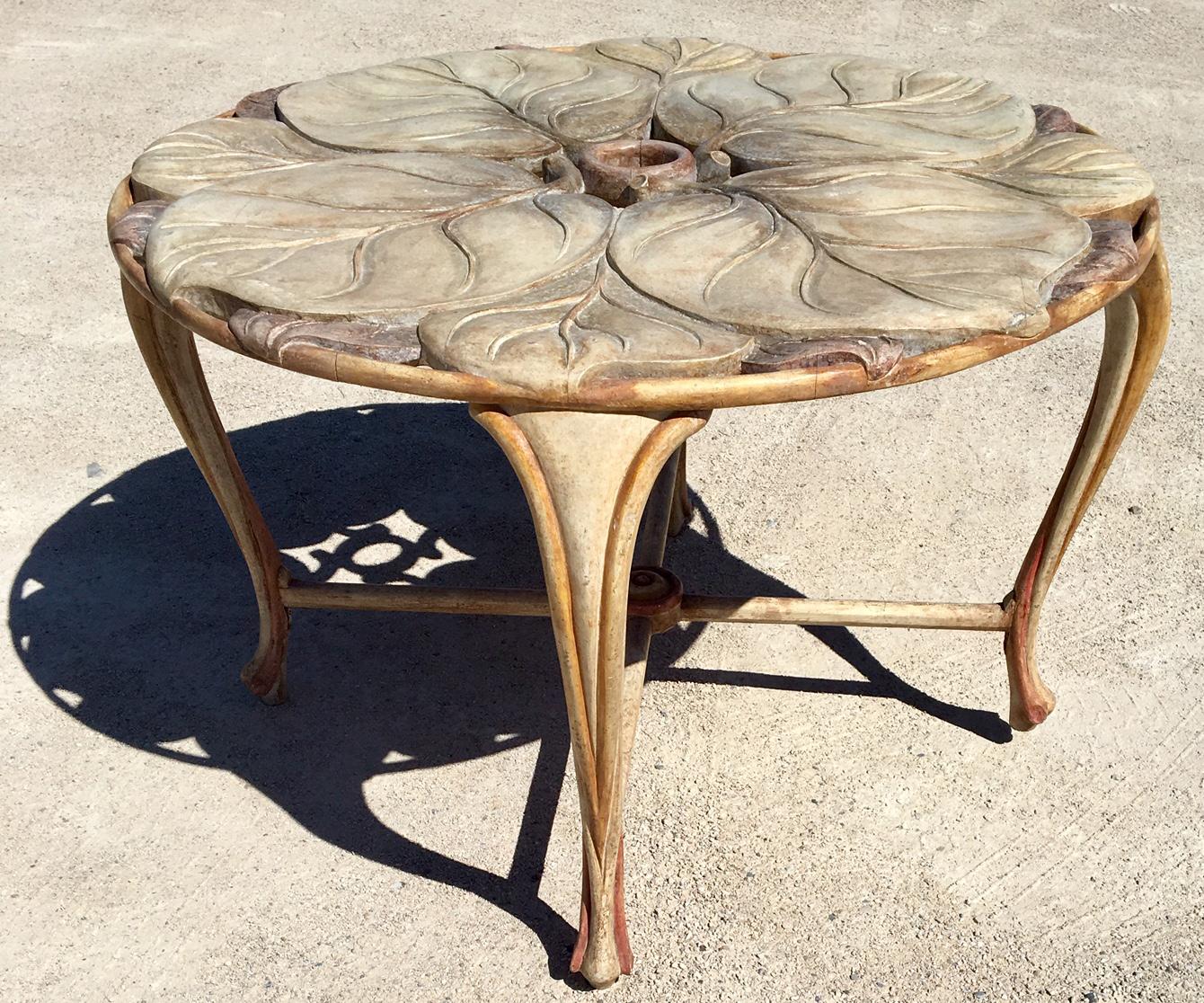 Unique vintage round dining table made of carved wood, Italy, 1970s. The tabletop is decorated with large carved leafs.