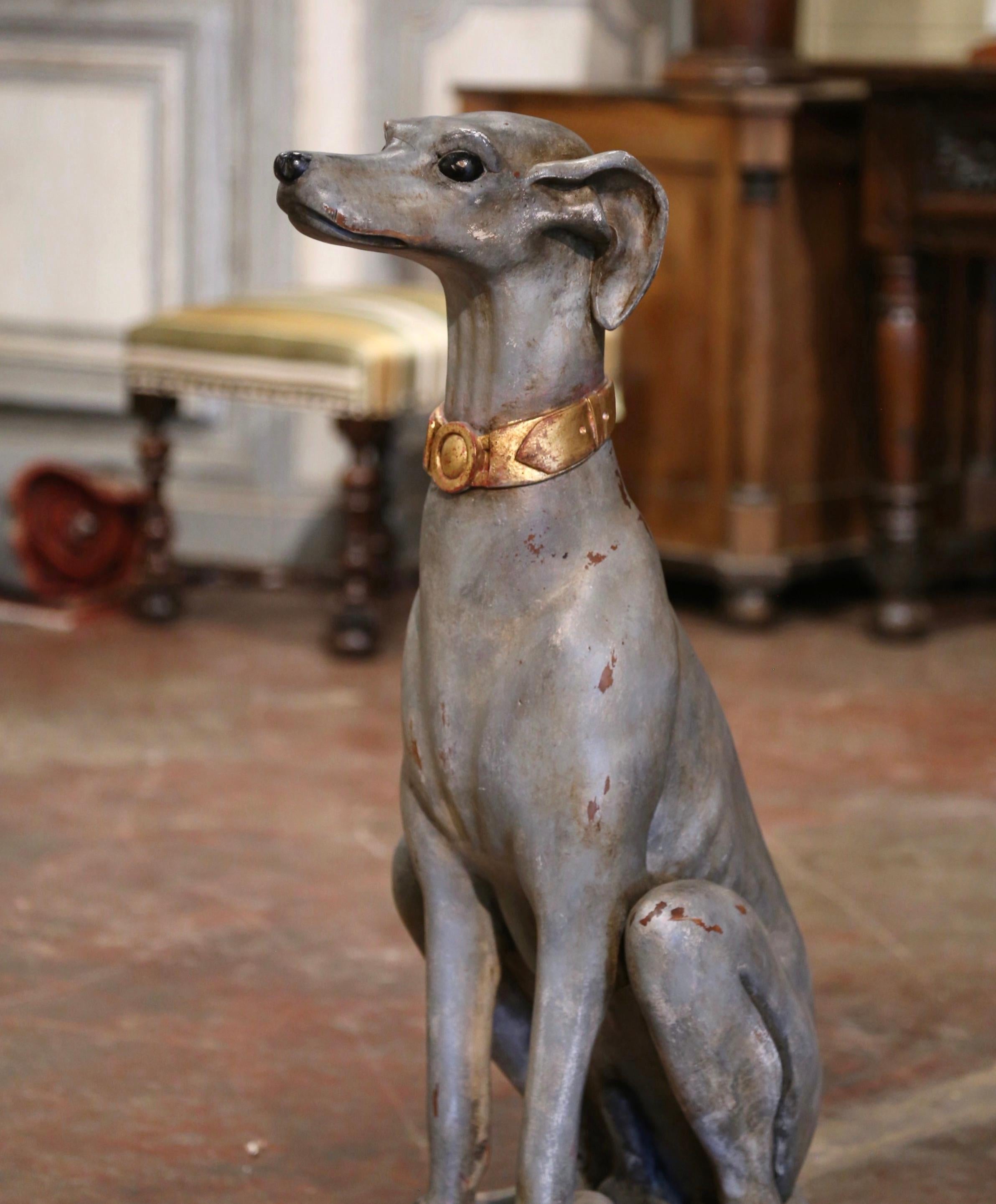 Hand carved near Venice, Italy, circa 1960, this large antique sculpture sits on an integral square red and gilt wooden pillow base; it features a greyhound figure sitting on back legs, its head up at attention as if ready to follow any command