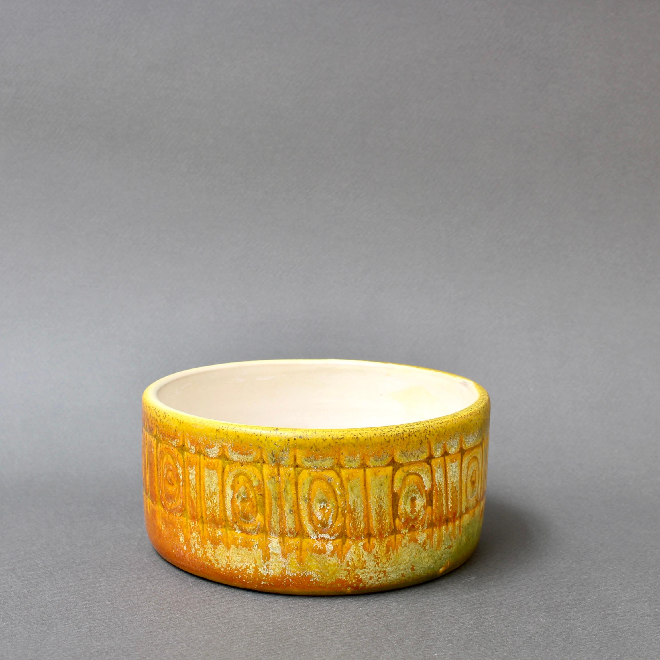 Vintage Italian ceramic bowl by Alessio Tasca (1962). A delightful frieze of geometric shapes encircle the piece. The fading colours in yellow and orange simply add even more character to a vintage piece by this world renowned Italian ceramicist.