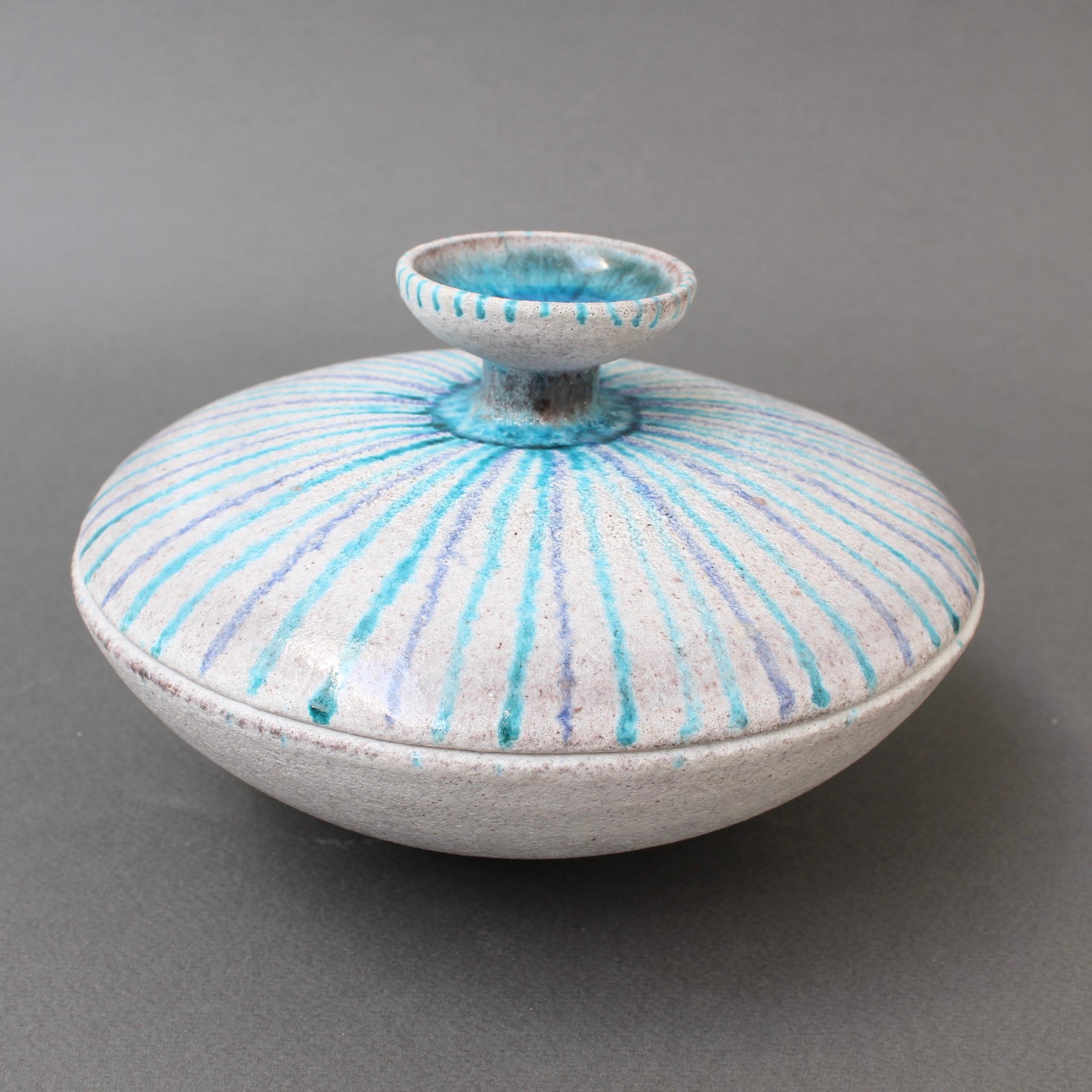 Vintage Italian decorative ceramic candy dish by Guido Gambone (circa 1950s). A flying saucer shaped dish with cover is painted with alternating blue and turquoise stripes emanating from the top centre handle, itself fashioned in the form of a