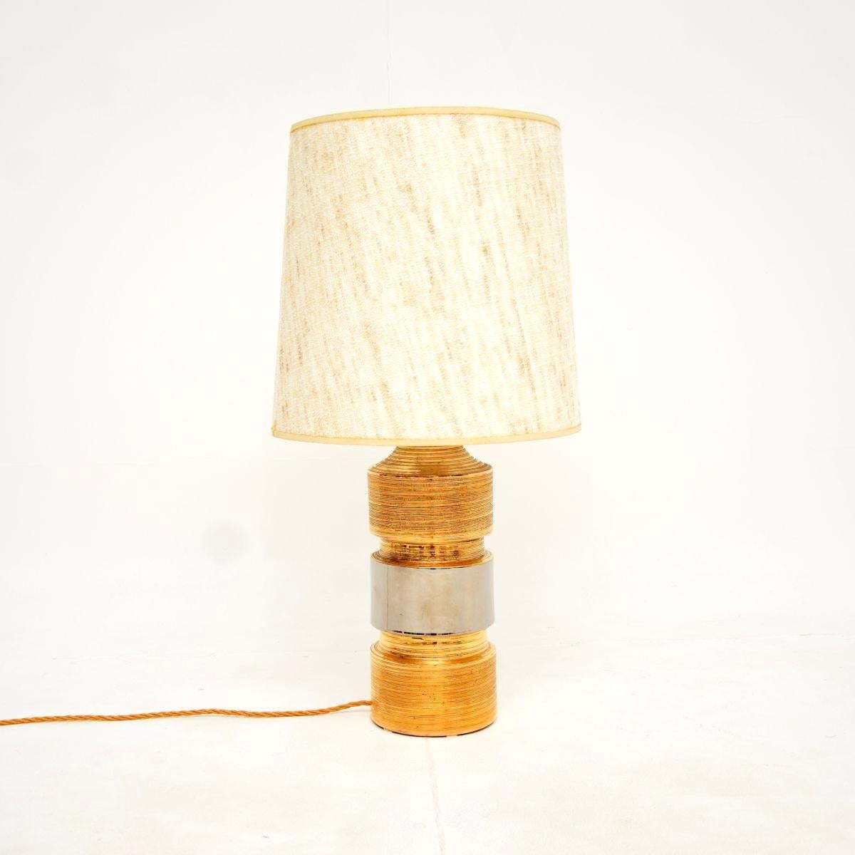 A stunning vintage Italian ceramic table lamp by Bitossi. This was designed by Aldo Londi, it was made in Italy and dates from around the 1970’s.

It is of wonderful quality, with a gorgeous spun design and gold finish, wit a silvered central