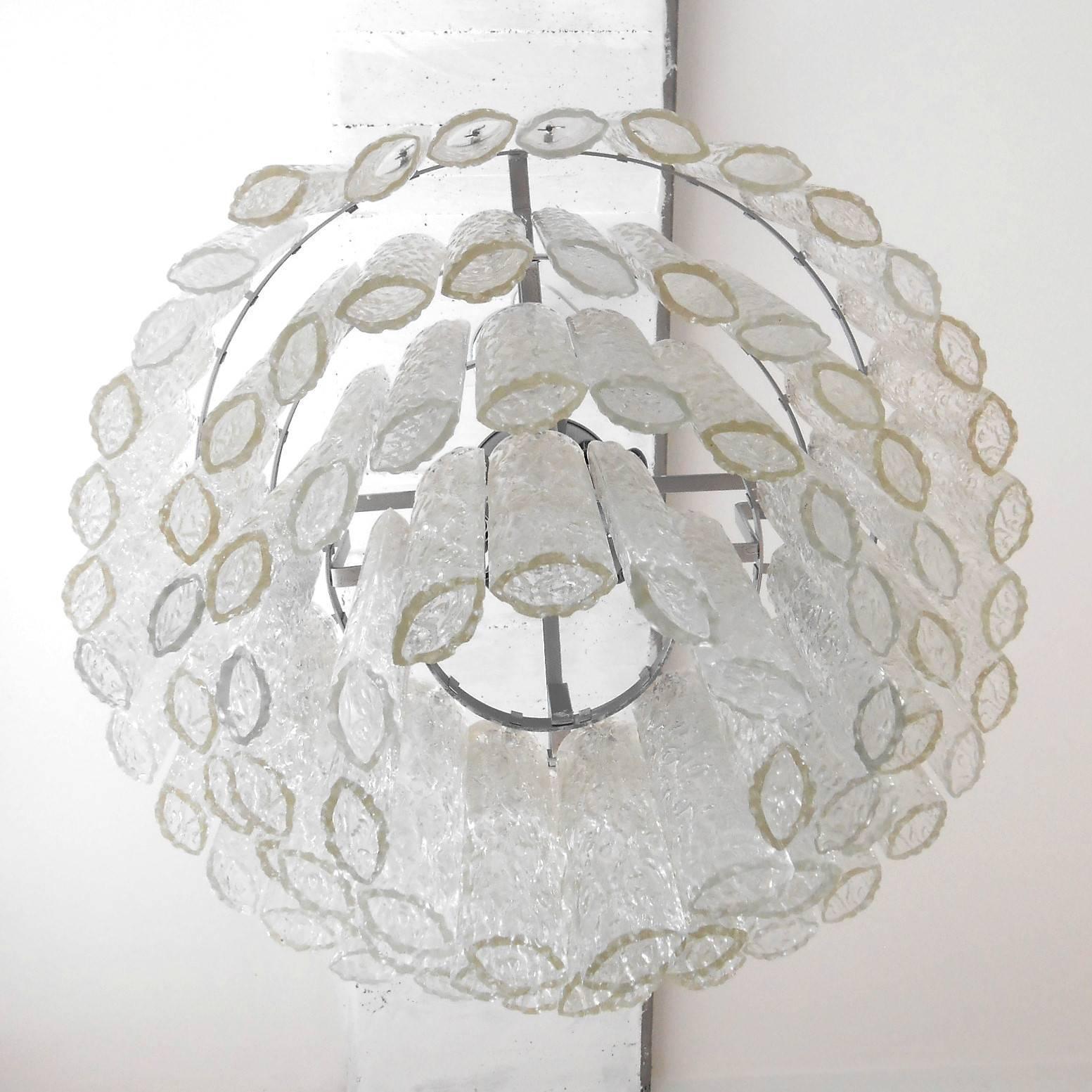 Vintage Italian chandelier with clear Murano glass tubes blown into beautiful oval shapes with textured designs, mounted on a tiered silver metal frame / Designed by Venini circa 1960’s /made in Italy.