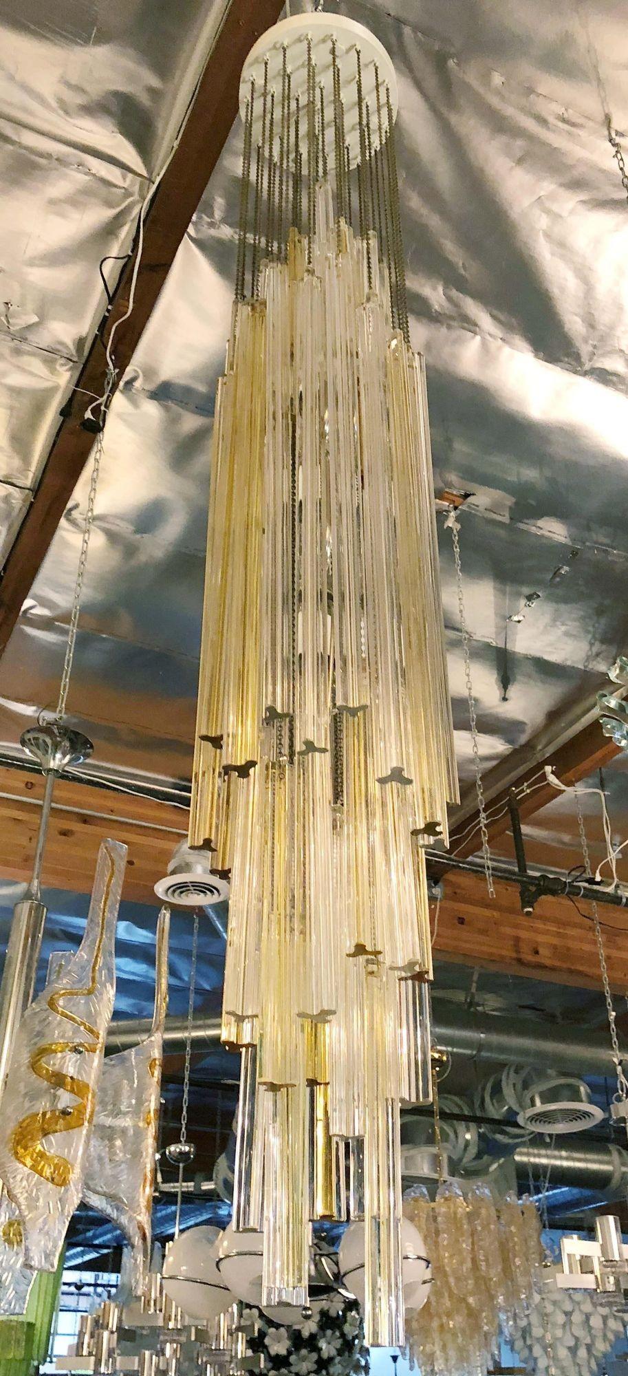 Vintage Italian chandelier with clear and gold Trilobo glasses suspended from white metal ceiling plate. Made by Venini, Italy, c. 1960's. 
Dimensions:
61