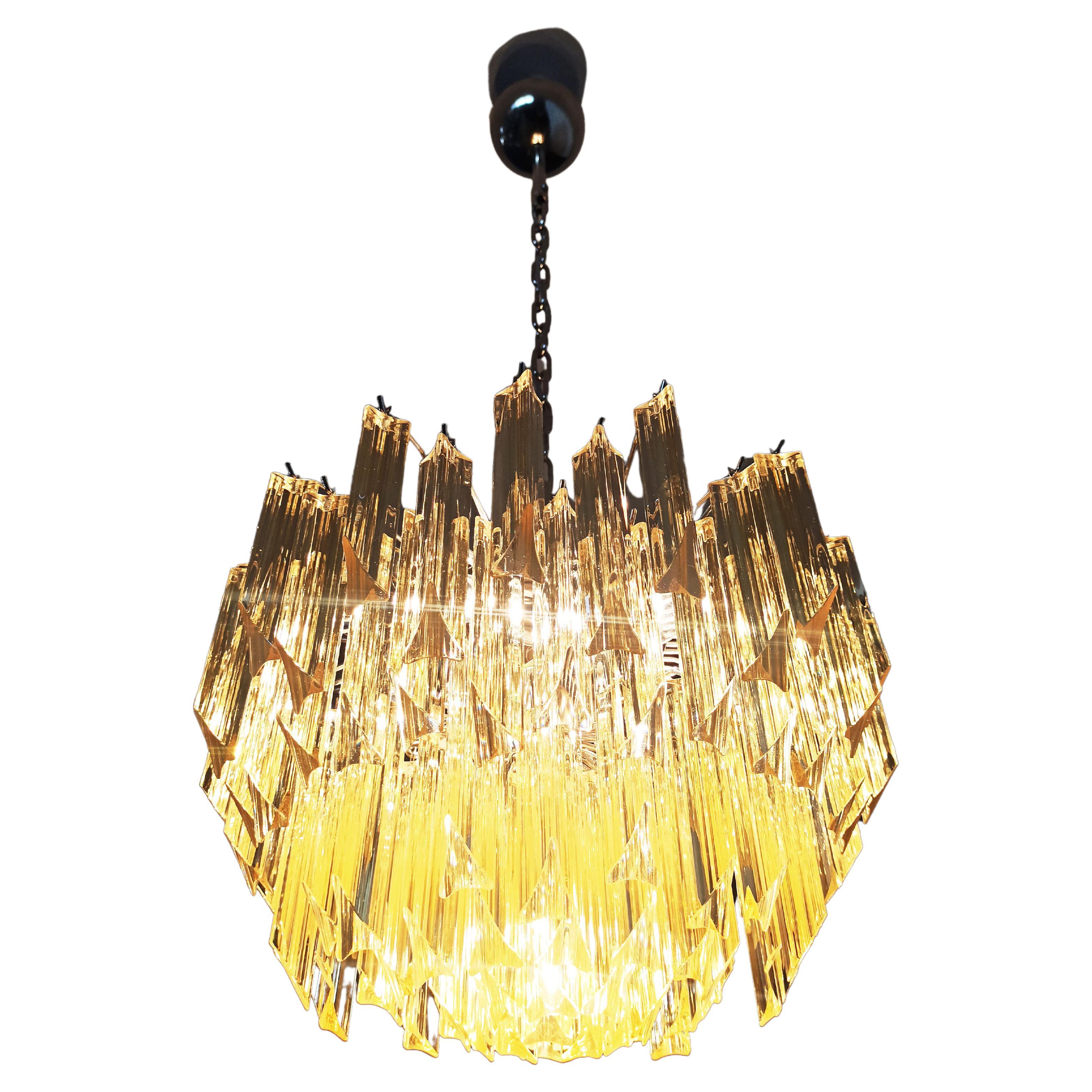 Fantastic vintage Murano chandelier made by 107 Murano crystal clear amber prism triedri in a nickel metal frame. Period: 1980'S
Dimensions: 41,90 inches height (108 cm) with chain; 17,70 inches height (45 cm) without chain; 17,70 inches diameter