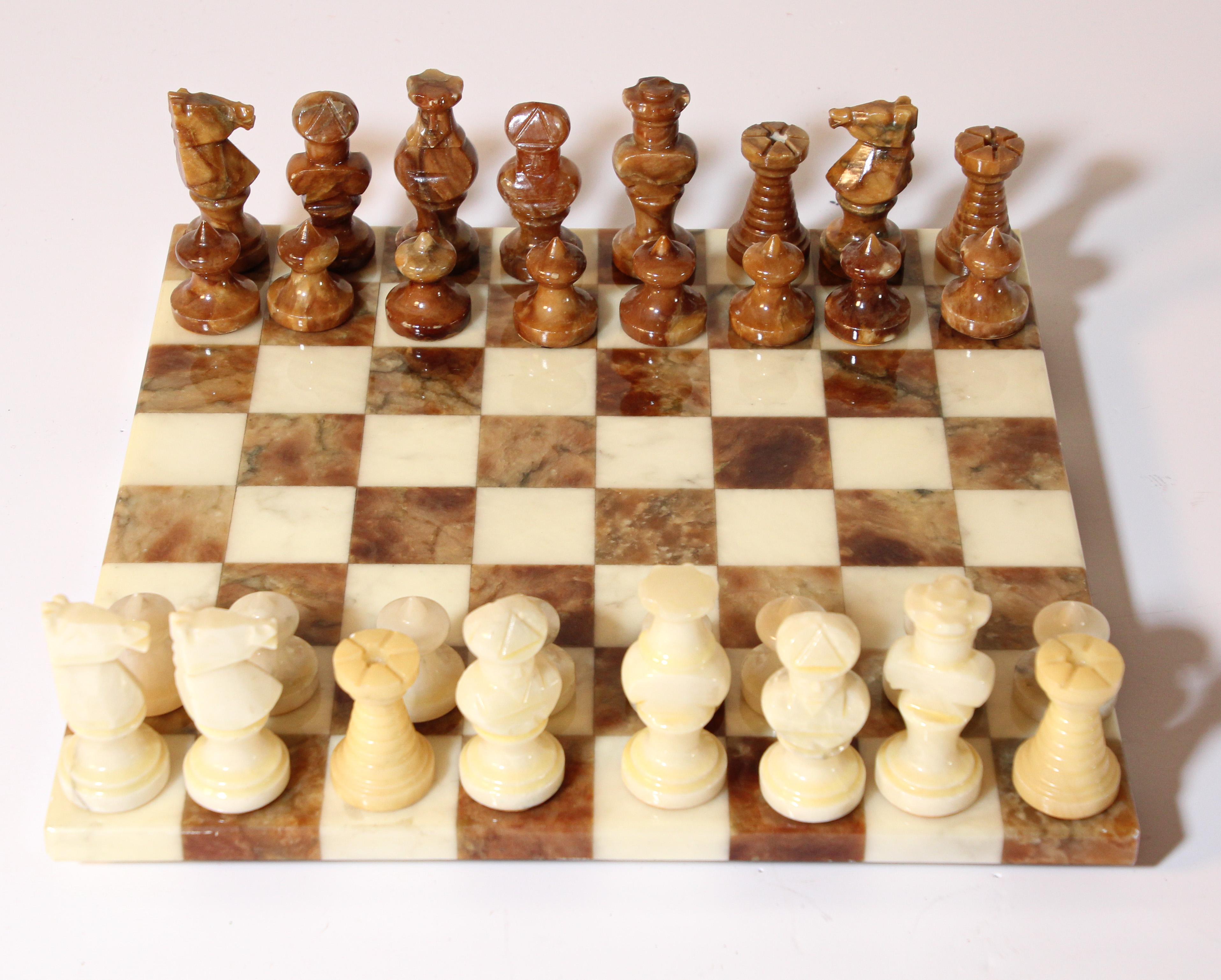 Vintage large heavy alabaster chess set complete board in brown onyx and white with elaborately onyx hand carved chess pieces with felted bottom and each stamped.
Contains all its pieces that are beautifully carved and polished. 
The pieces are