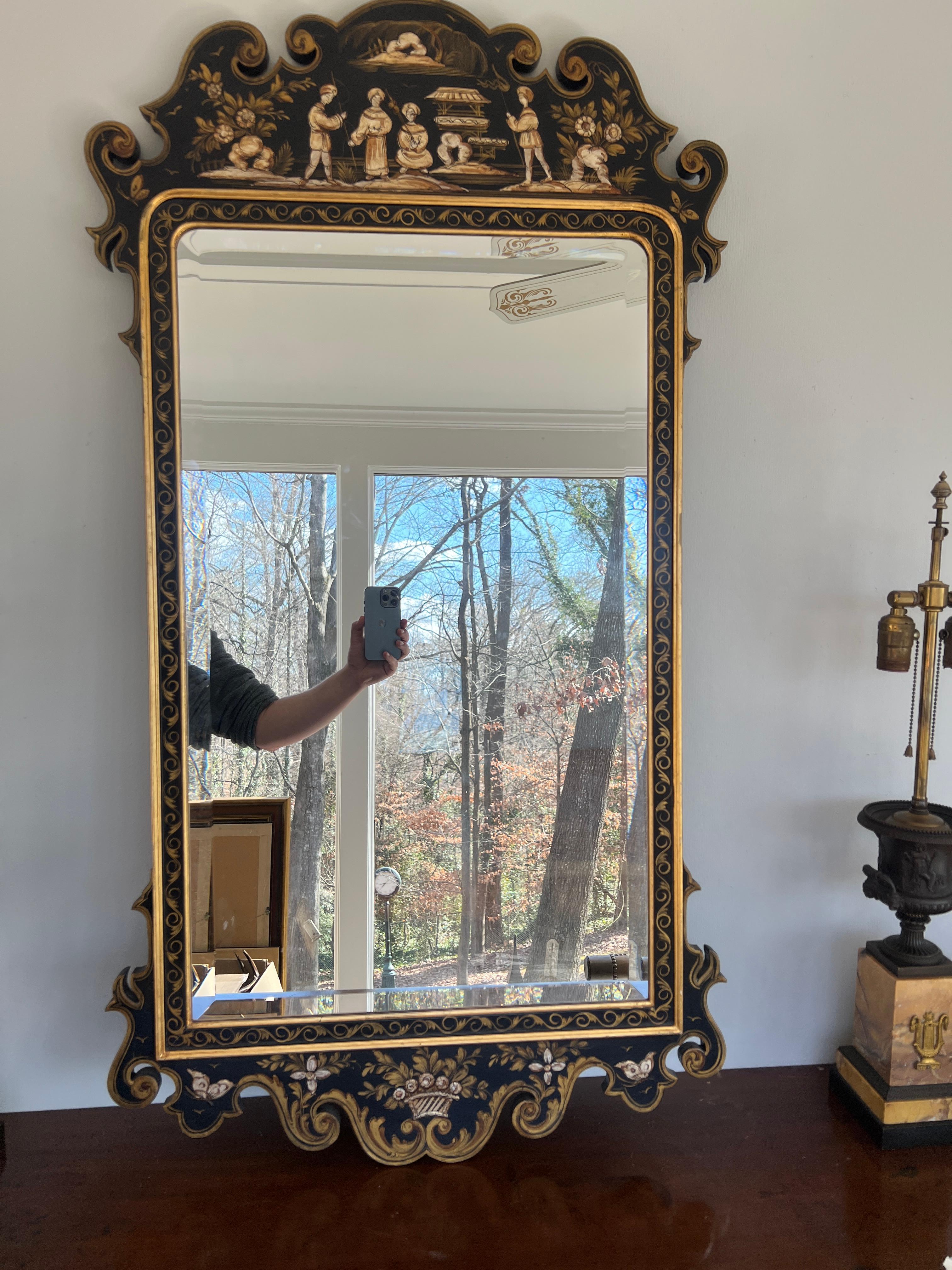 Italian, circa 1960.

A well decorated black and gold chinoiserie decorated wall mirror in the chippendale taste. Mirror plate has beveled glass and original back to mirror.