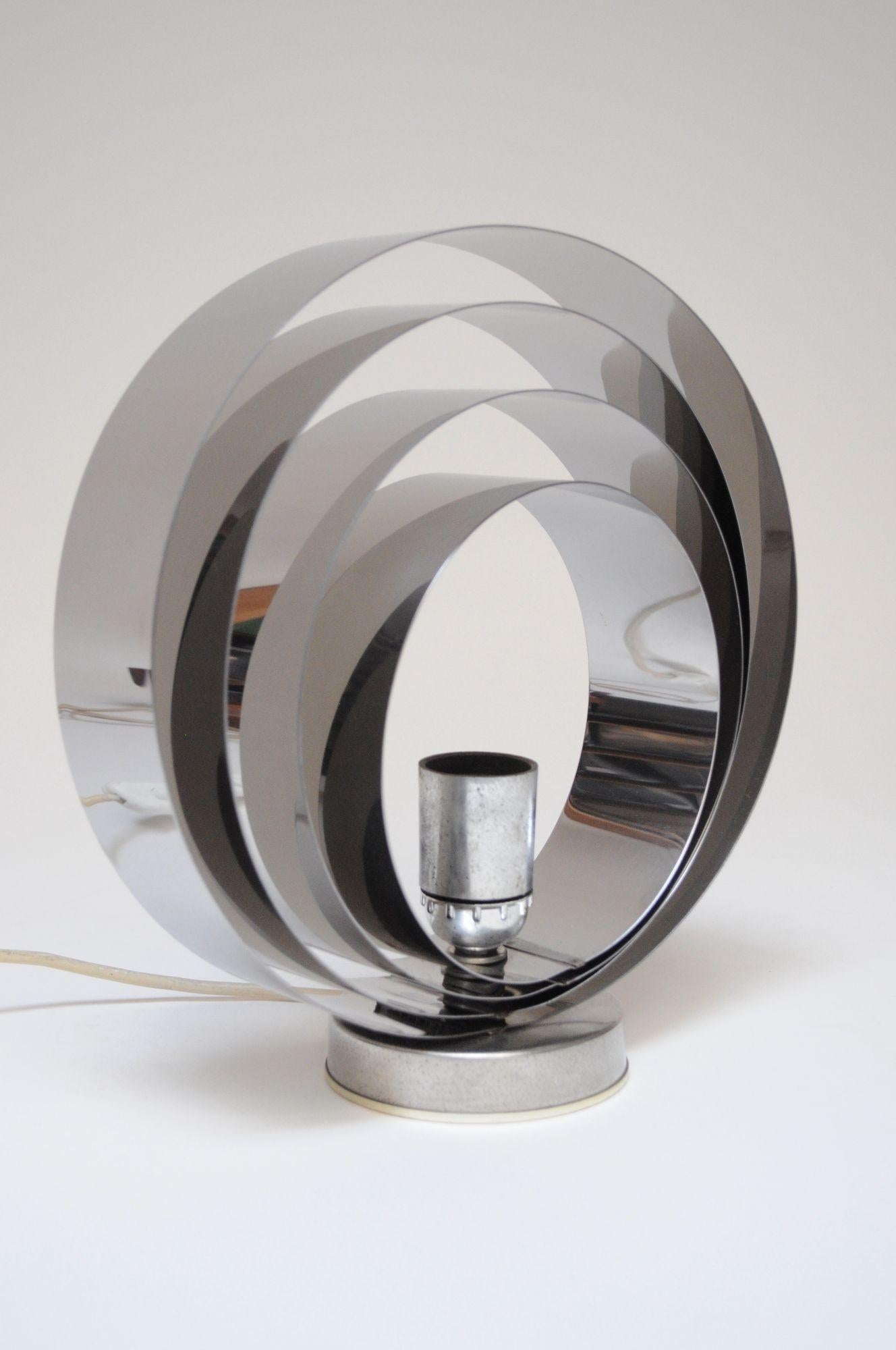 Vintage Italian table lamp / sconce / flush-mount composed of four layers of chrome rings / concentric circles which can fan out to create an armillary sphere reminiscent of various 