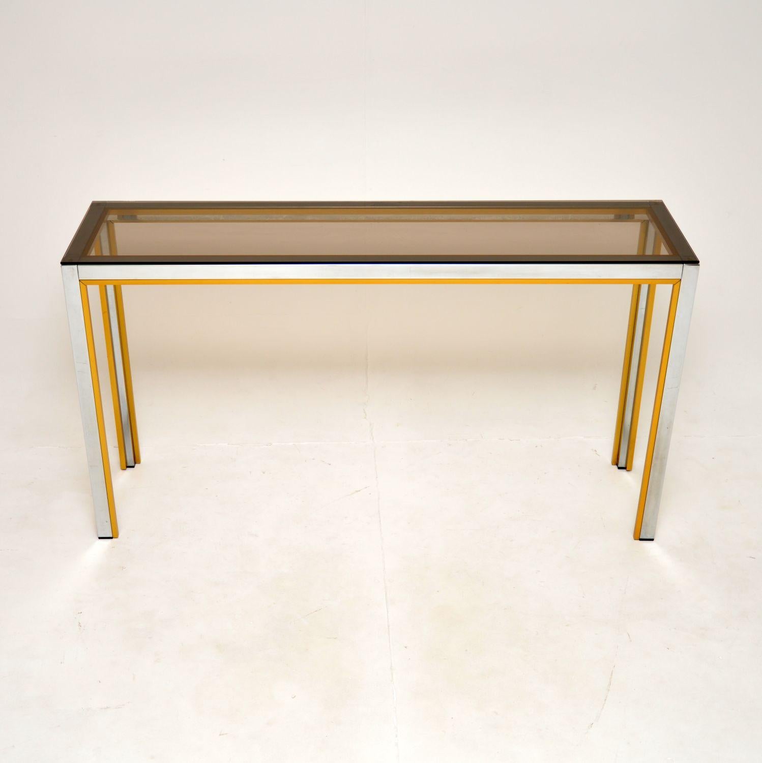 A stylish and very well made vintage Italian chrome console table by Zevi. This was made in Italy in the 1970’s, it was originally retailed by Harrods.

The quality is lovely, this has a gorgeous chrome frame with gold toned aluminium strips on the