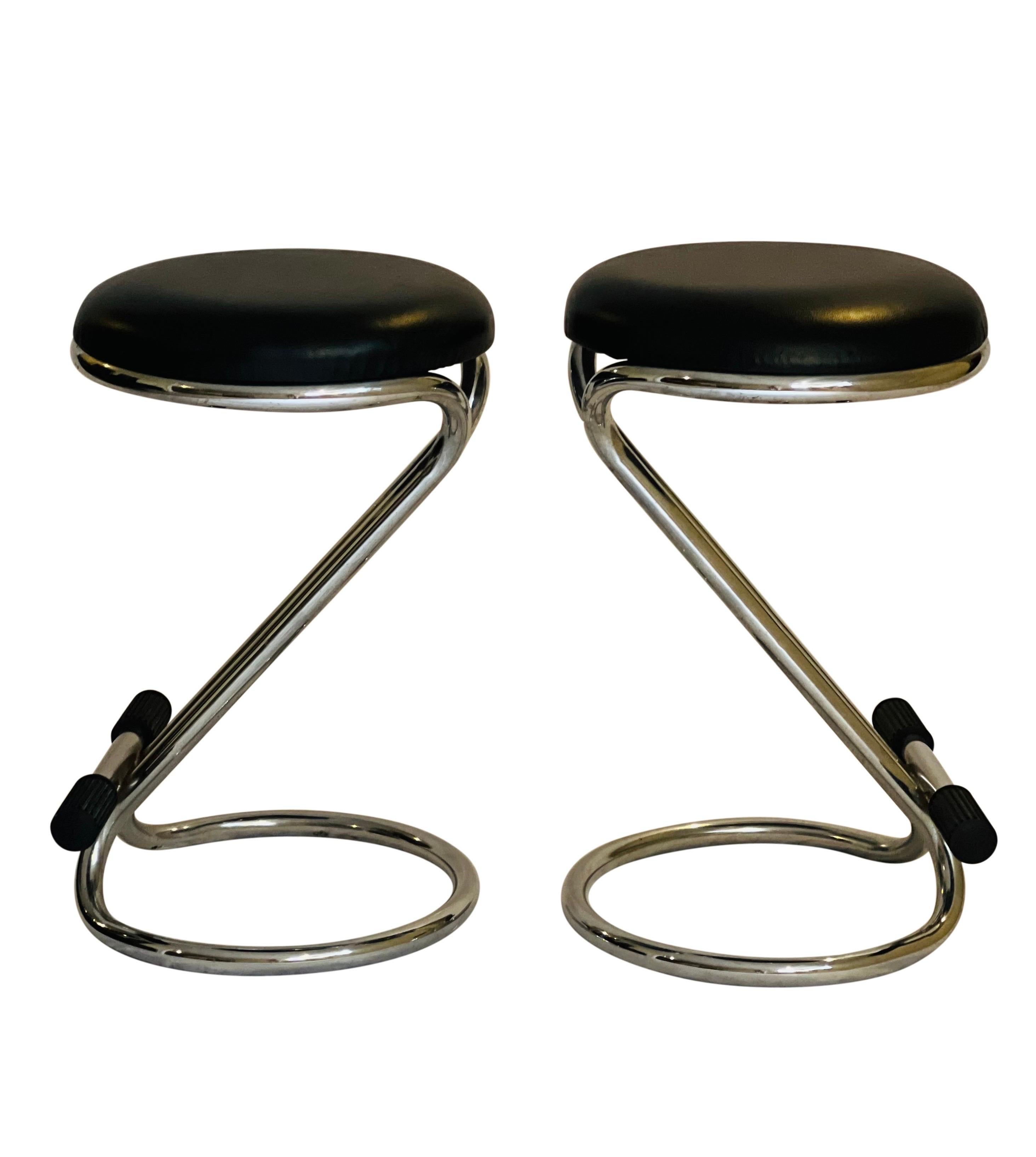 Exceptional pair of Italian tubular chrome counter height stools with Z base frame by Bieffeplast, Padova.

Stools feature a nicely cushioned, ample faux leather seat with a comfortable, thickly texturized rubber footrest. The stools are expertly