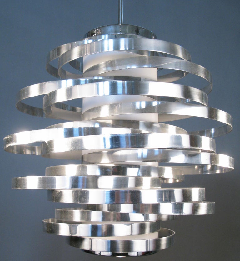 a stunning and dynamic vintage 1970's Italian hanging light designed by Max Sauze for Sciolari. one of his best designs, composed of a series of graduated bands of chromed steel, all attached to a central column of light, with the bands placed so