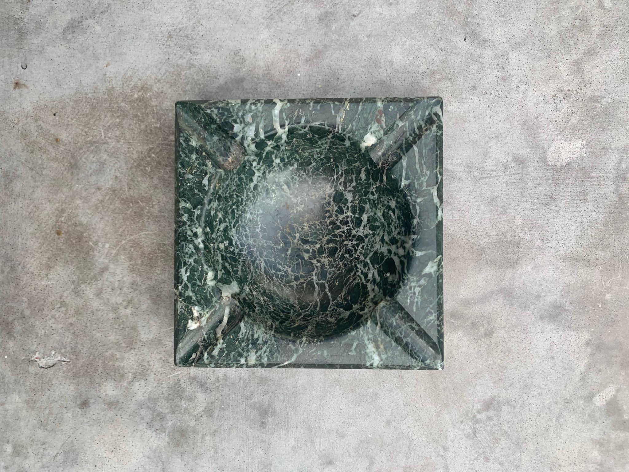 A rare vintage Italian marble ashtray in pine green with intricate dove gray veining, 1960s. Hand -carved in Italy. Minor signs of wear consistent with age and use. 
Dimensions:
5.25” x 5.25” x 1.75”