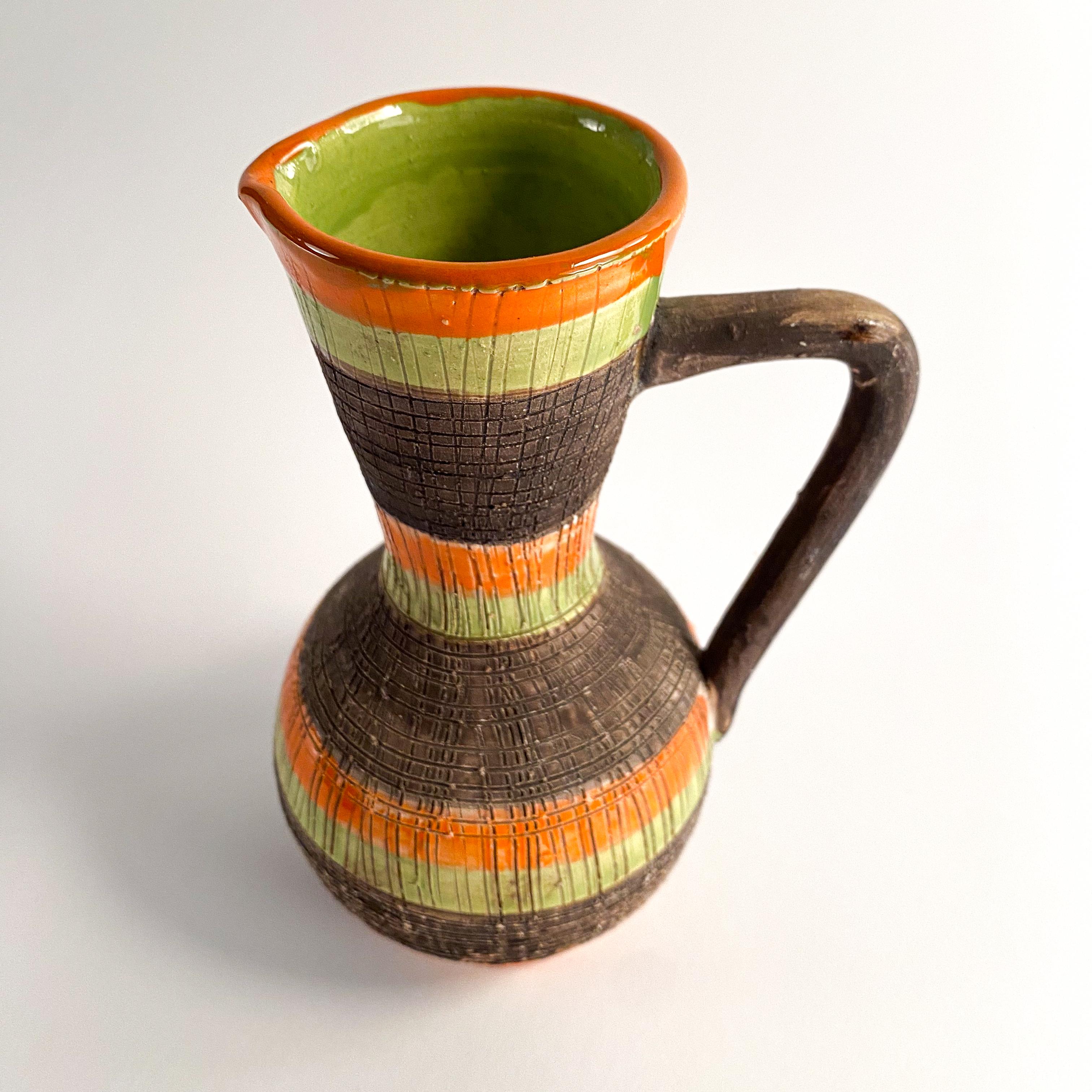 great looking ceramic pitcher vase. has good colors, brown green and orange. marked made in Italy on the underside.