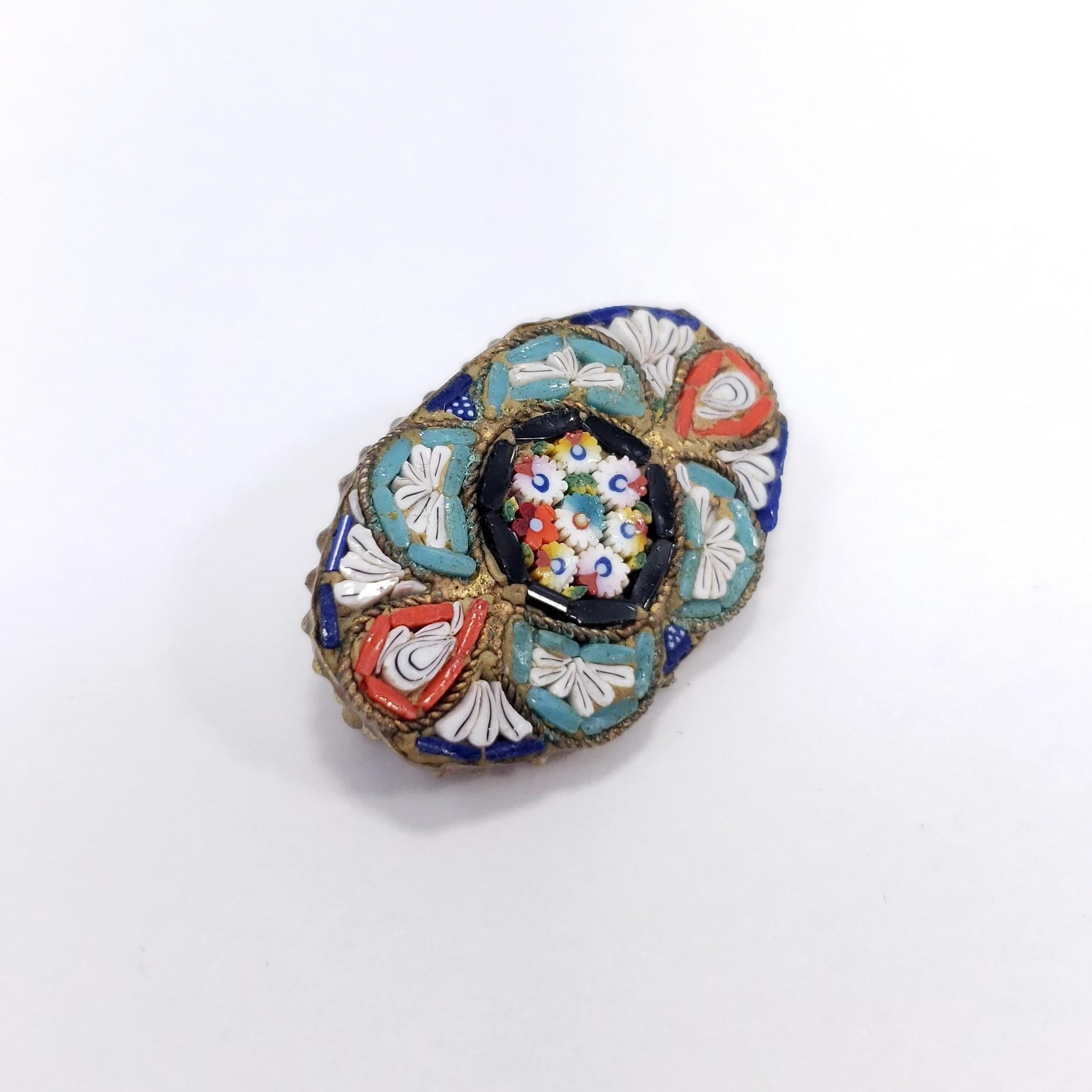 A stylish Italian cloisonne pin brooch with blue, orange, white, and turquoise floral motifs. Brass-tone setting. Circa early to mid 1900s.

Tags, Marks, Hallmarks: Made in Italy