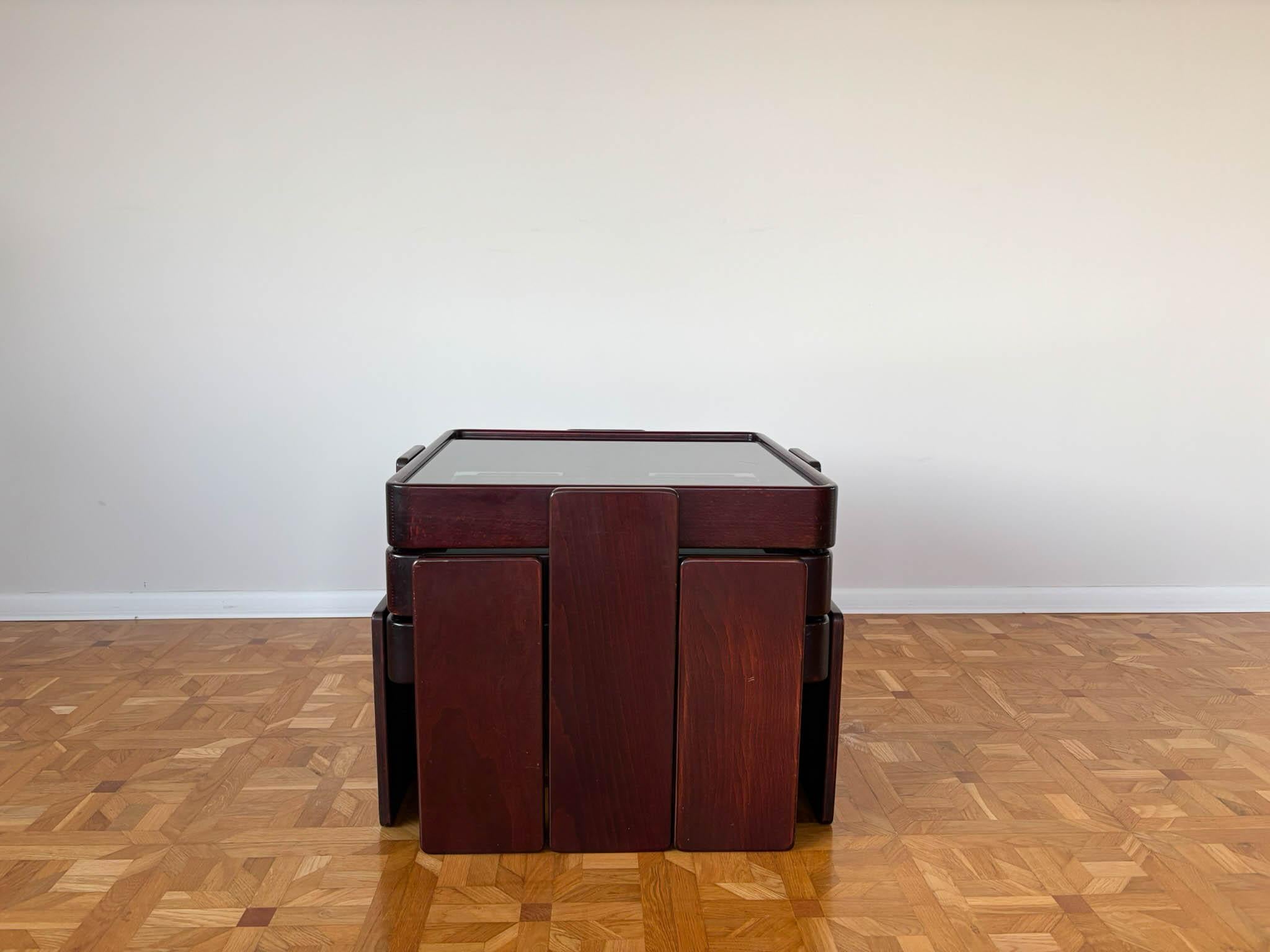 Vintage Italian Coffee Tables by Gianfranco Frattini for Cassina
A set of 3 mid-century modern coffee tables made of wood with smoked glass tops. Designed by Gianfranco Frattini for Cassina, these tables come in three different heights (29 cm, 37.5