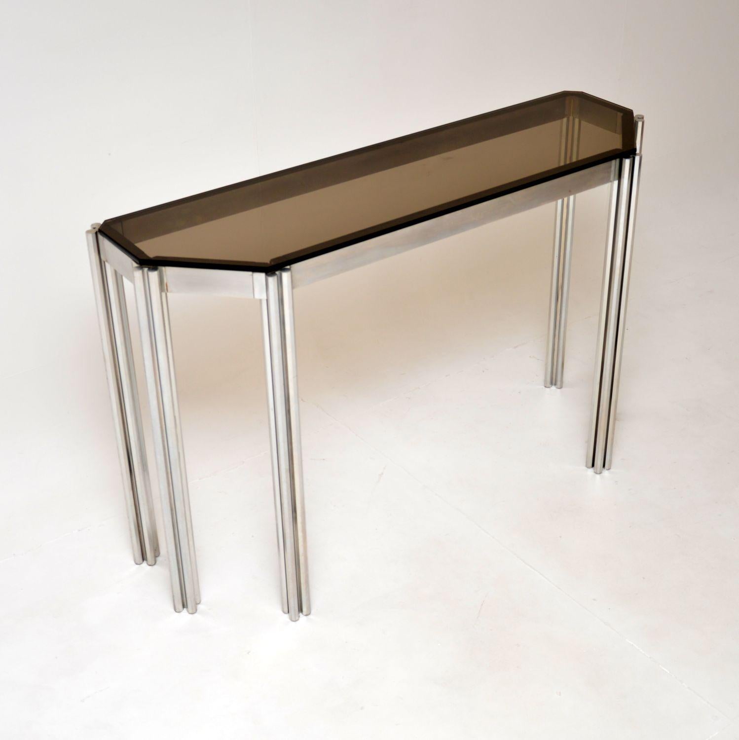 A stunning designer vintage Italian console table by Alessandro Albrizzi. This was made in Italy, it dates from the 1970’s.

The quality is outstanding, this has a very thick and well made brushed steel frame, with an extra thick glass top.

The
