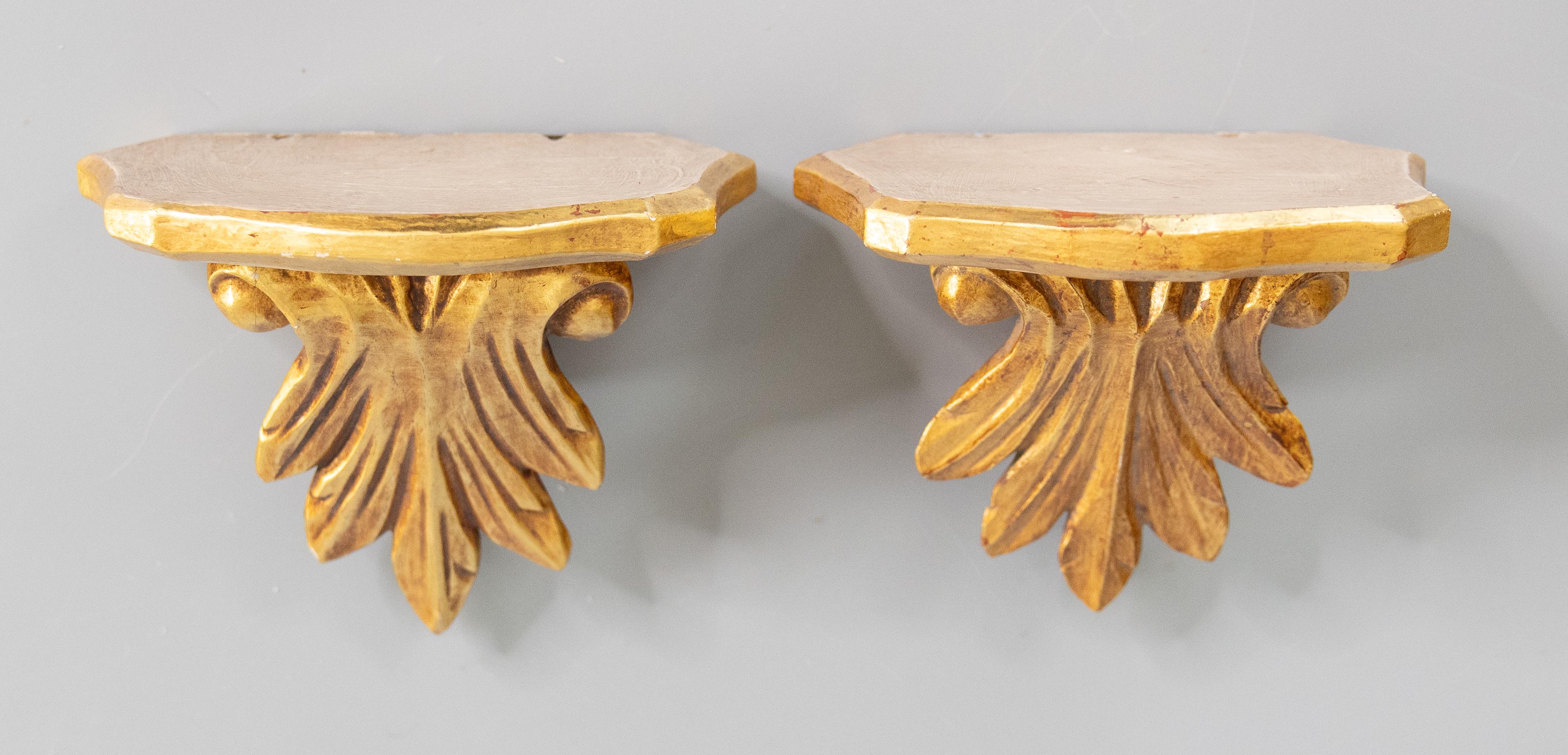 Mid-Century Italian carved acanthus leaf gilt wood wall brackets or shelves. Perfect for displaying decorative collectibles or wonderful displayed on their own.