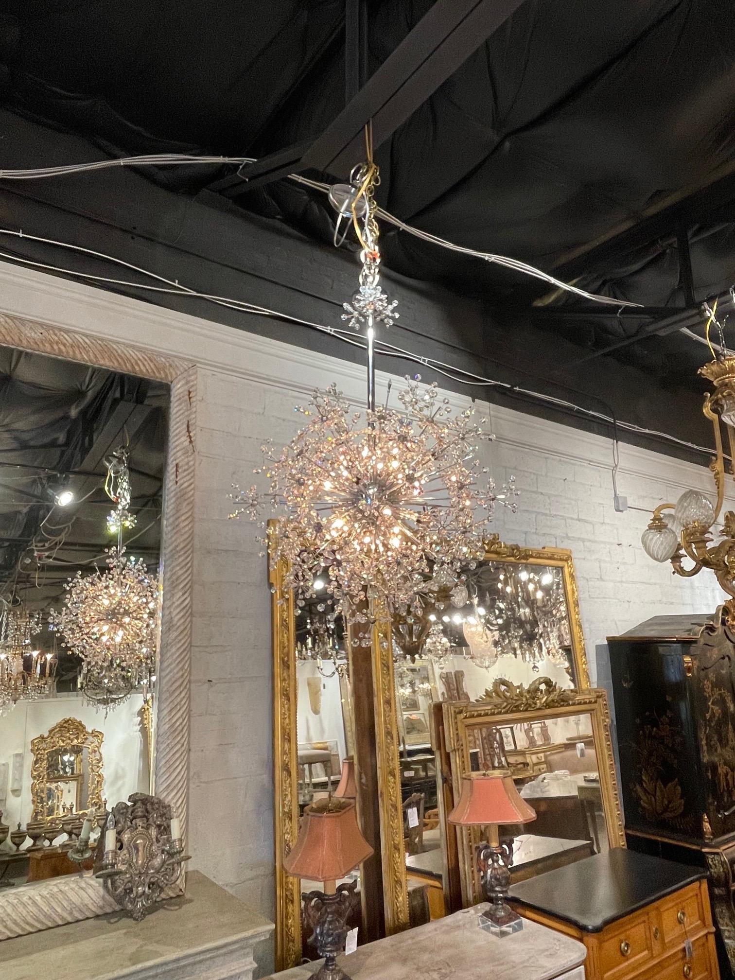 Stunning vintage Italian sputnik crystal chandelier on a chrome frame. The piece is covered in a multitude of glistening crystals including some in the shape of a flower. Creates a fun retro vibe. So pretty!