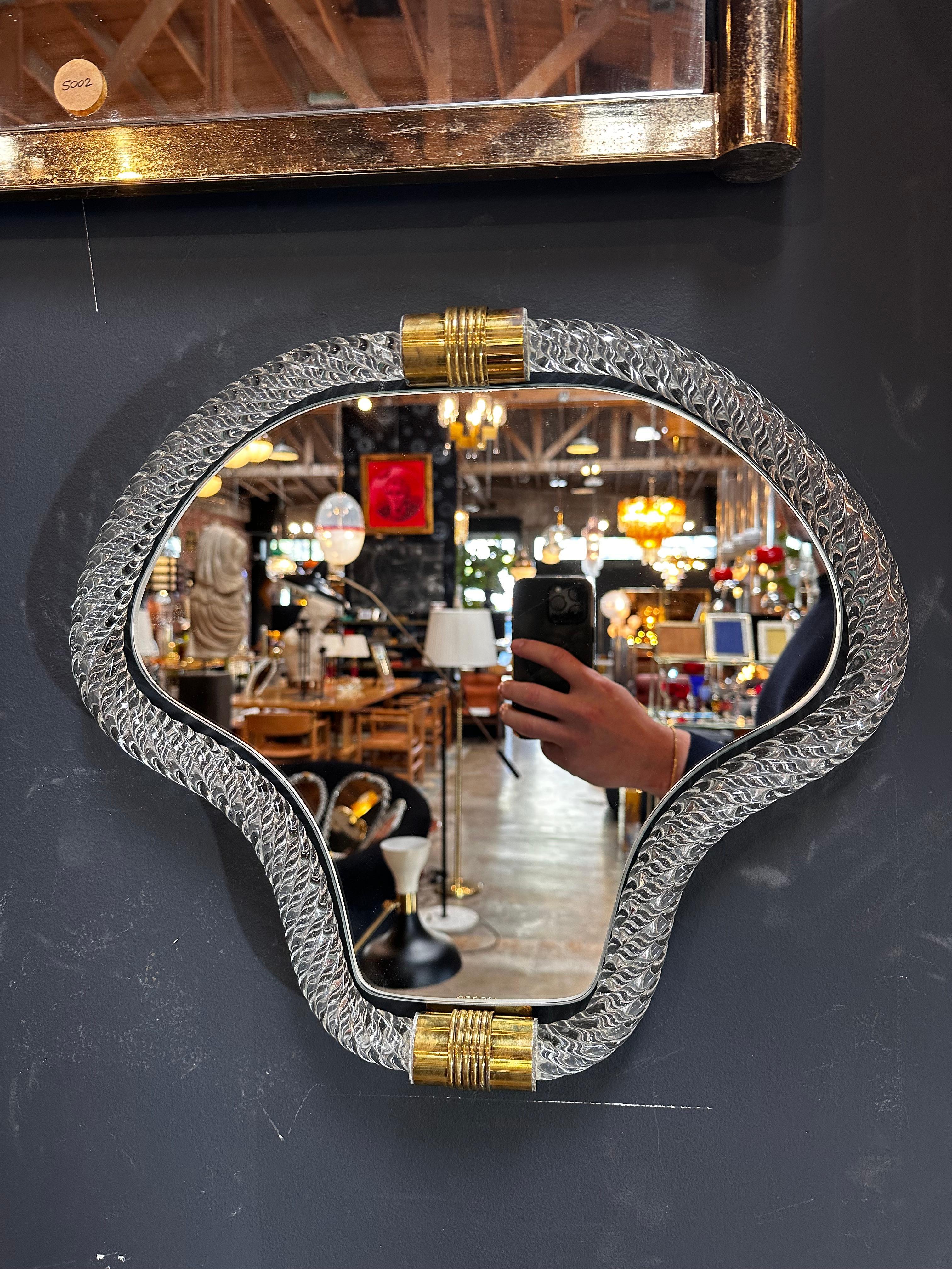 Elevate your space with our Vintage Italian Mid Century Murano Wall Mirror from the 1940s. This exquisite piece boasts a Murano  frame, showcasing the craftsmanship of the era. Brass details accentuate its elegance, creating a unique and timeless