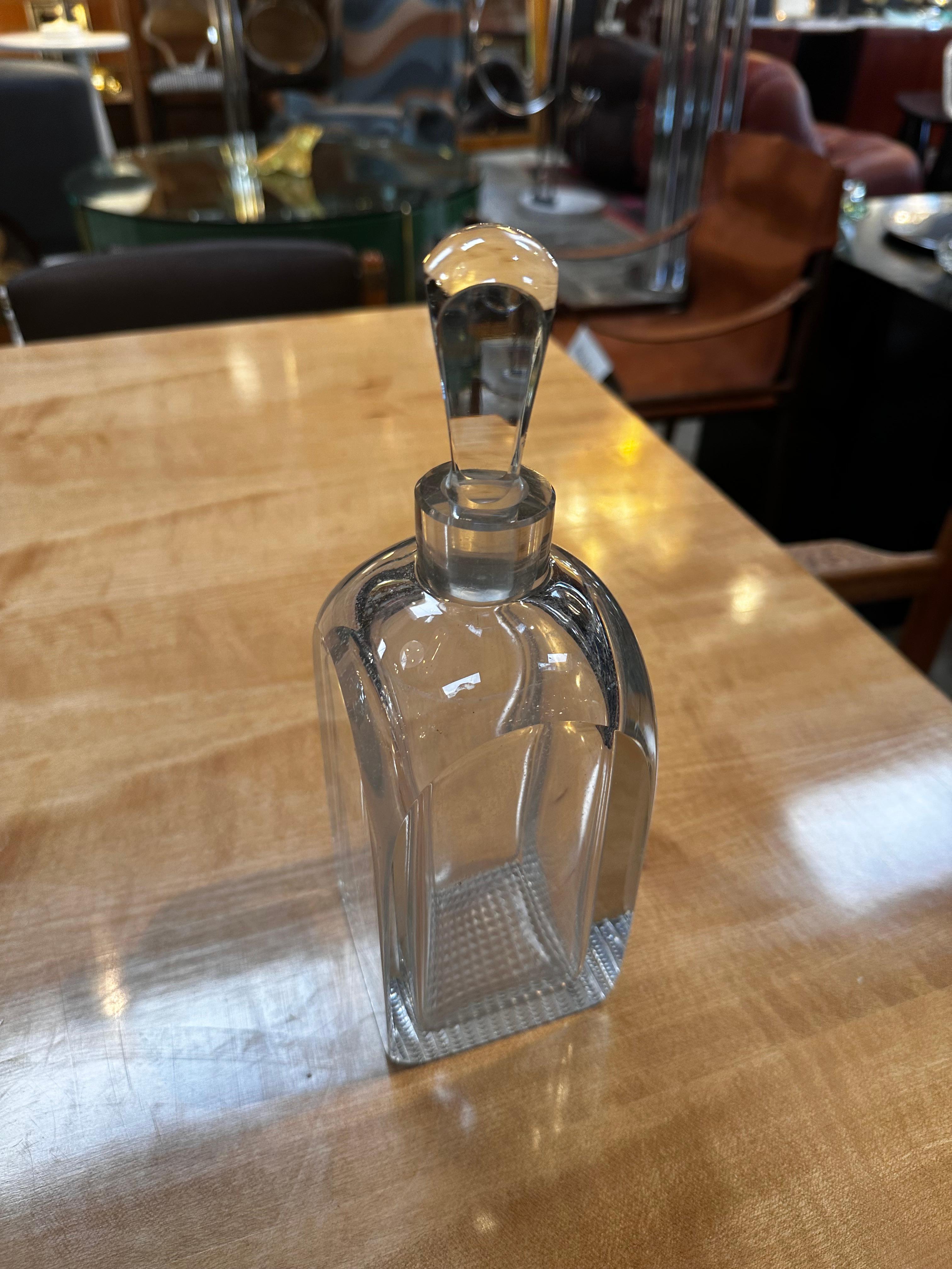 The Vintage Italian Decorative Crystal Decanter from the 1960s is a classic and refined piece of barware. Crafted in Italy during the mid-20th century, this decanter is made of high-quality crystal, showcasing both elegance and craftsmanship. Its