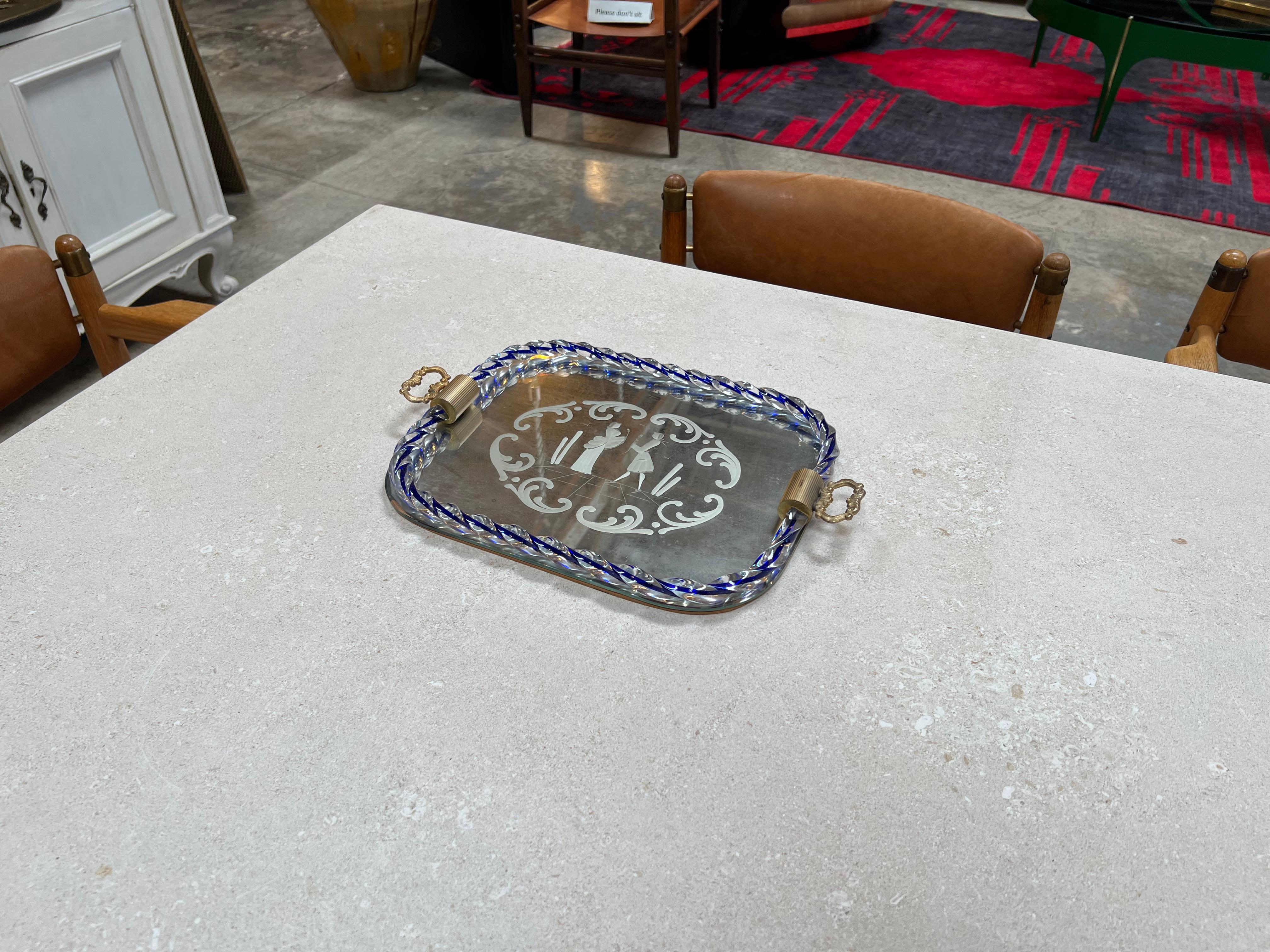 The Vintage Italian Decorative Murano and Mirror Tray from the 1950s is a captivating piece that marries the renowned Murano glass artistry with the functionality of a mirror tray. Originating from Italy, this tray showcases intricate Murano