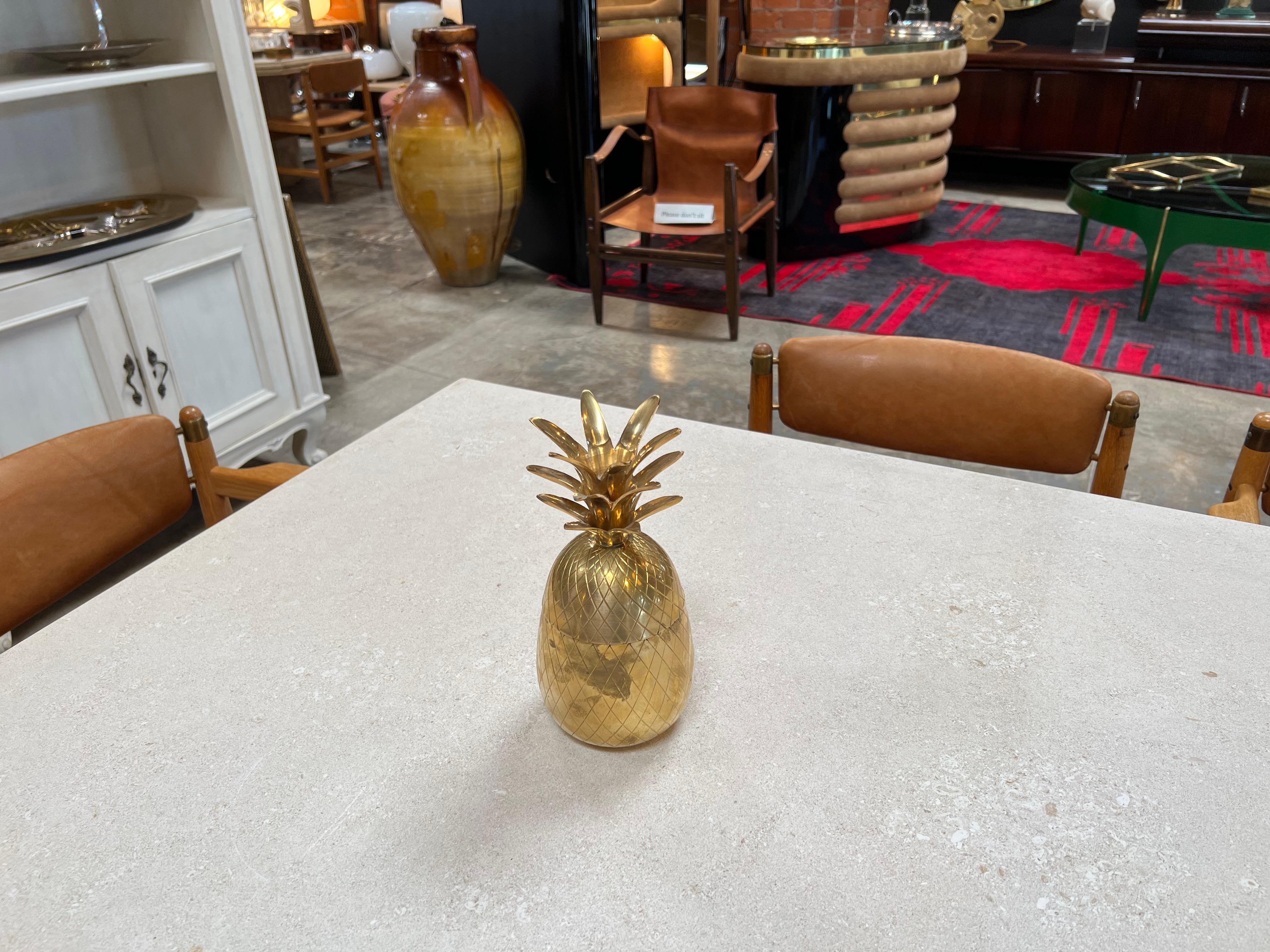 The Vintage Italian Decorative Pineapple Brass Box from the 1970s is a charming and unique collectible. Crafted in Italy, this brass box is shaped like a pineapple, showcasing both artistic design and functionality. Its vintage appeal and