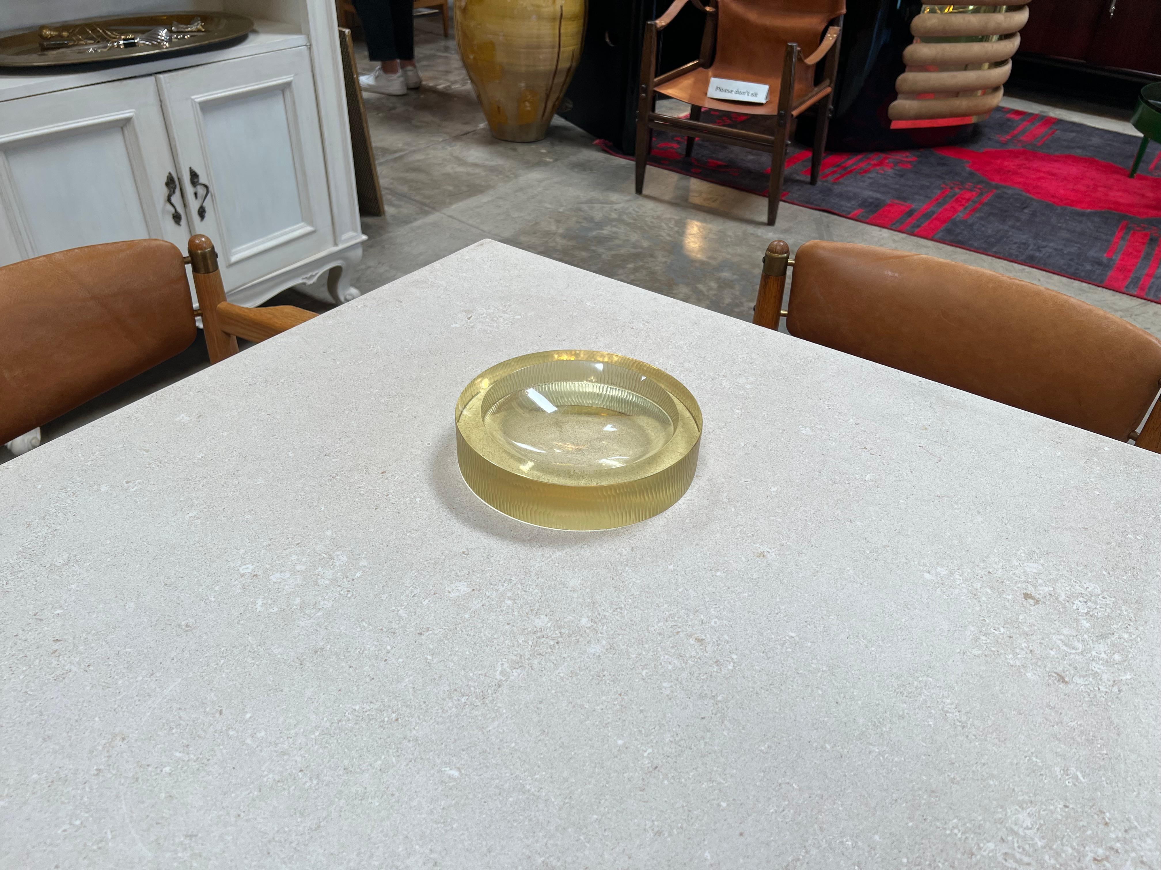 The Vintage Italian Decorative Round Glass Bowl from the 1970s is a charming piece that encapsulates the era's design aesthetics. Made in Italy, this bowl features a round and elegant form, showcasing the beauty of glass craftsmanship. Its vintage